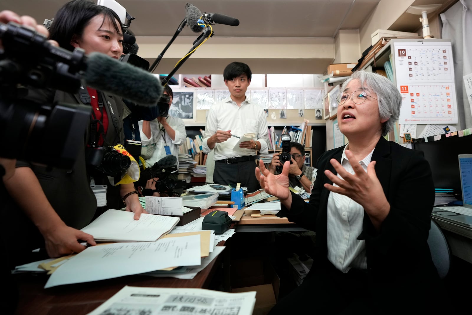 Masako Kudo, an official of Nihon Hidankyo, or the Japan Confederation of A- and H-Bomb Sufferers Organizations, speaks to media members at its Tokyo office in Tokyo, Friday, Oct. 11, 2024, following Ninon Hidankyo's winning the Nobel Peace Prize. (AP Photo/Shuji Kajiyama)