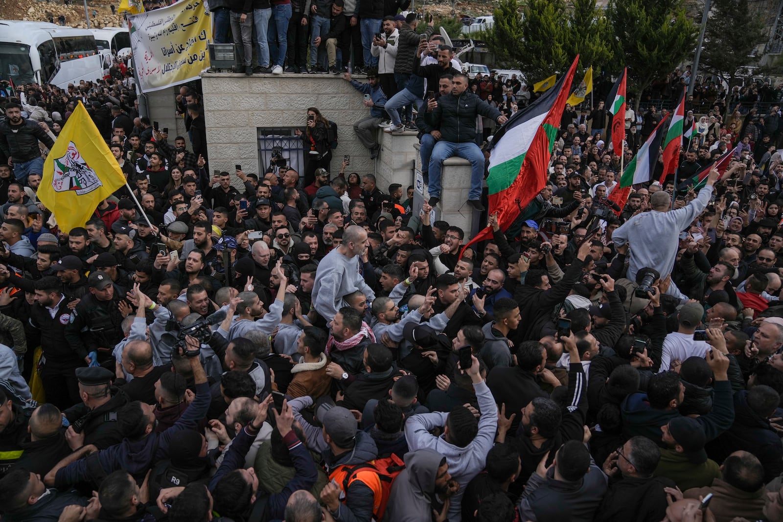 Palestinian prisoners are greeted by a crowd after being released from Israeli prison following a ceasefire agreement with Israel, in the West Bank city of Ramallah, Saturday, Jan. 25, 2025.(AP Photo/Mahmoud Illean)