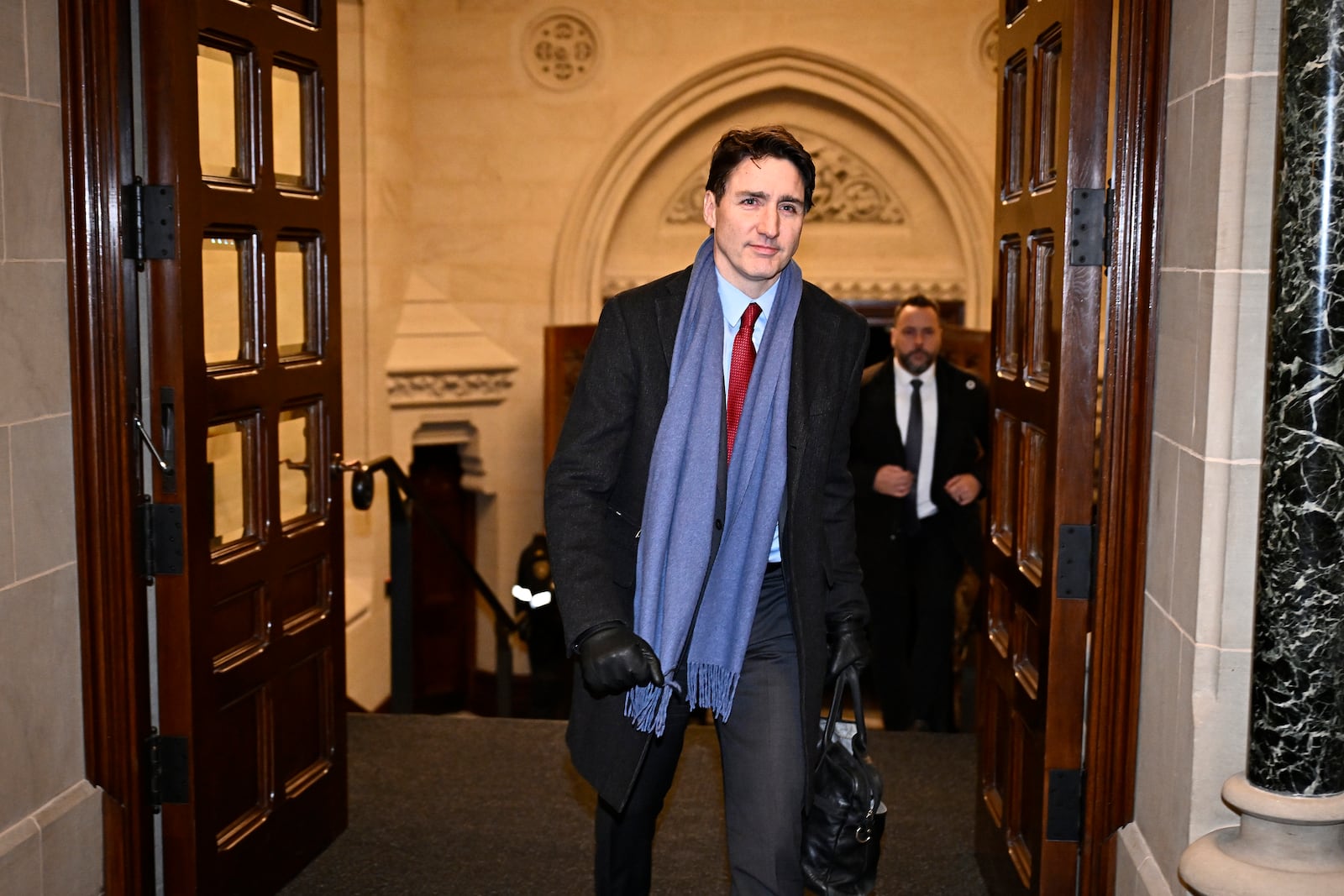 Canada's Prime Minister Justin Trudeau arrives to address media following the imposition of a raft of tariffs by U.S. President Donald Trump against Canada, Mexico and China, in Ottawa, Saturday, Feb. 1, 2025. (Justin Tang/The Canadian Press via AP)