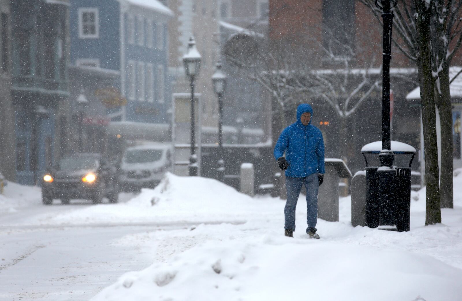 A person walks through the snow during a storm in Portsmouth, N.H., Thursday, Feb. 6, 2025. (AP Photo/Caleb Jones)