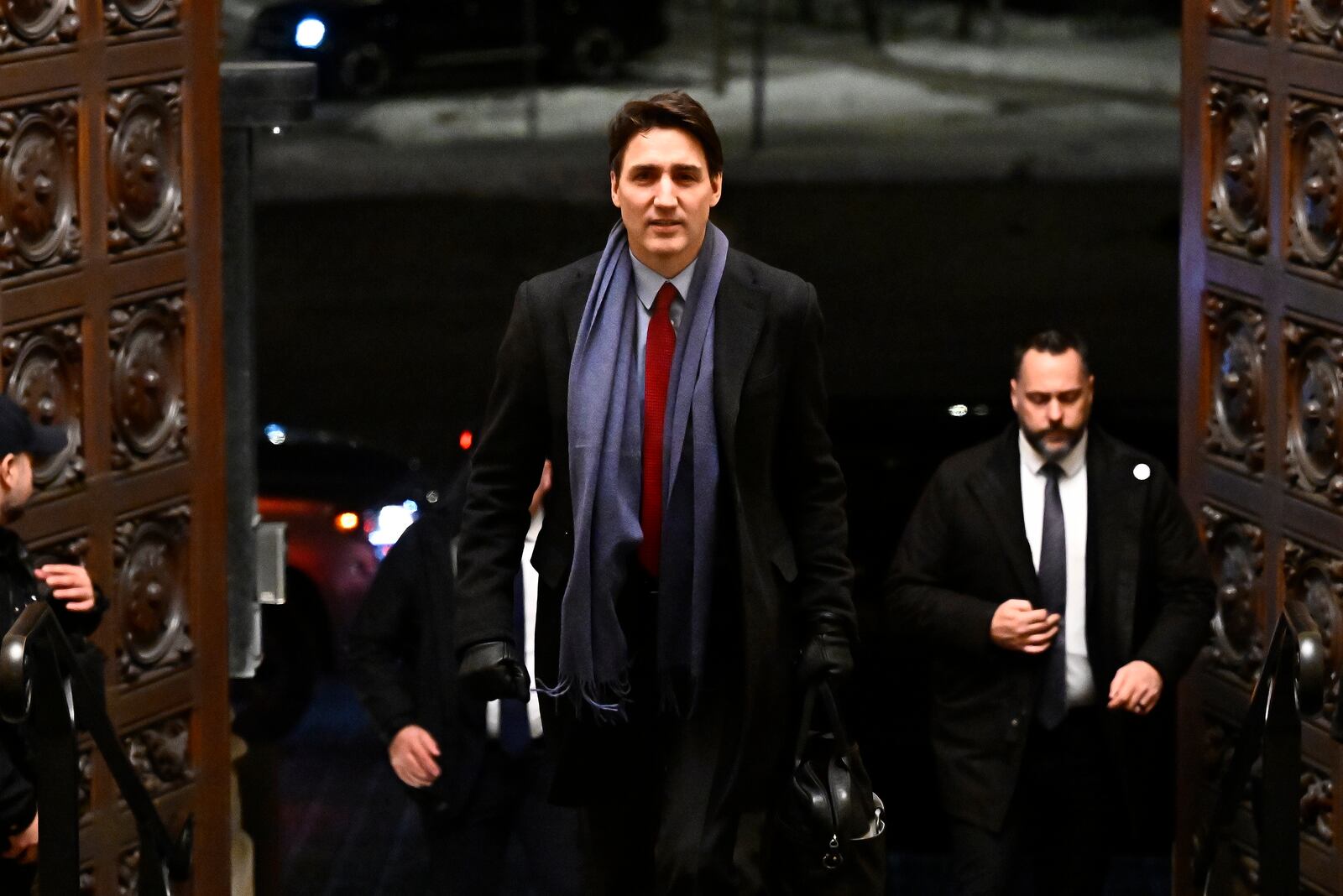 Canada's Prime Minister Justin Trudeau arrives to address media following the imposition of a raft of tariffs by U.S. President Donald Trump against Canada, Mexico and China, in Ottawa, Saturday, Feb. 1, 2025. (Justin Tang/The Canadian Press via AP)