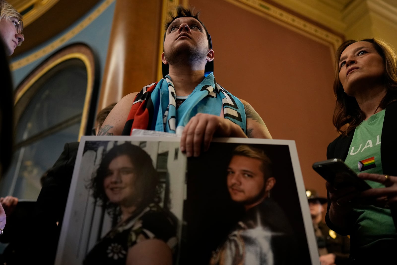 Laker Fuller and other protesters fill the Iowa state Capitol to denounce a bill that would strip the state civil rights code of protections based on gender identity, Thursday, Feb. 27, 2025, in Des Moines, Iowa. (AP Photo/Charlie Neibergall)