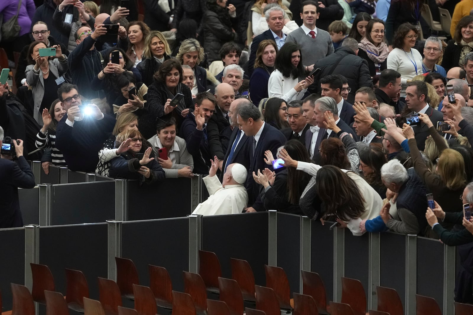 Pope Francis greets faithful as he leaves after an audience with Catholic associations of teachers and students' parents in the Paul VI Hall, at the Vatican, Saturday, Jan. 4, 2025. (AP Photo/Alessandra Tarantino)