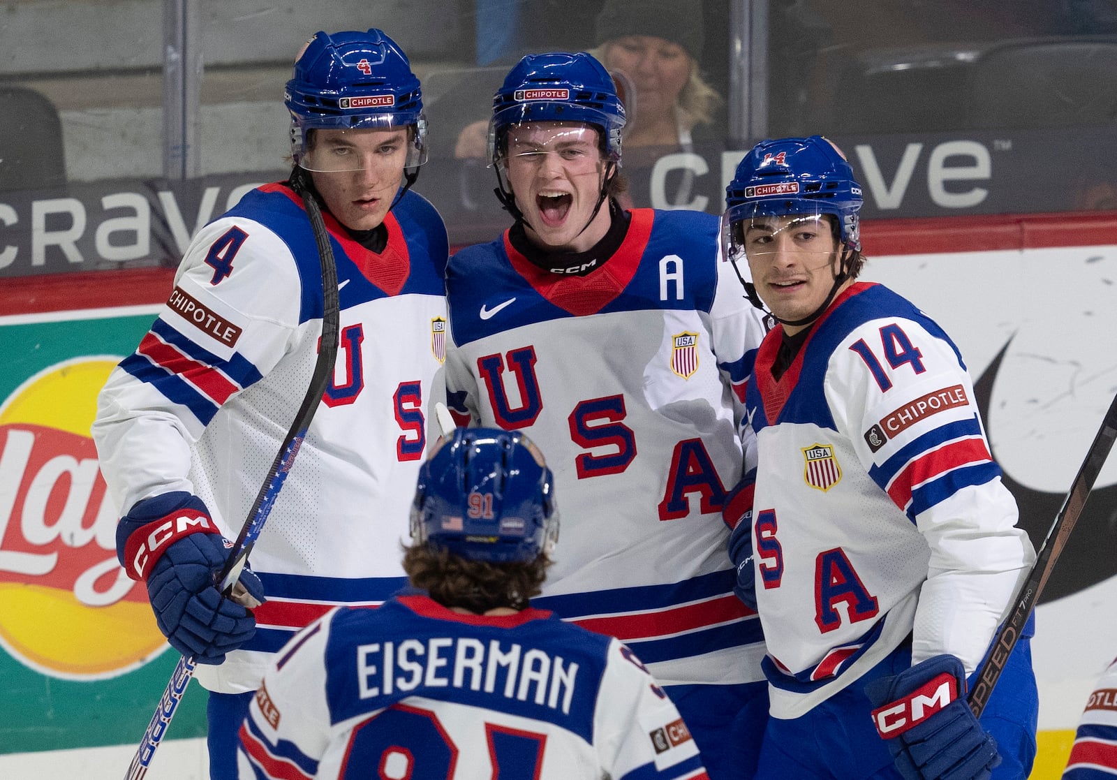 United States forward Danny Nelson, center, celebrates his goal with teammates defenseman Colin Ralph (4), defenseman Aram Minnetian (14) and forward Cole Eiserman during the first period of a IIHF World Junior Hockey Championship tournament game against Latvia, Saturday, Dec.28, 2024 in Ottawa, Ontario. (Adrian Wyld/The Canadian Press via AP)