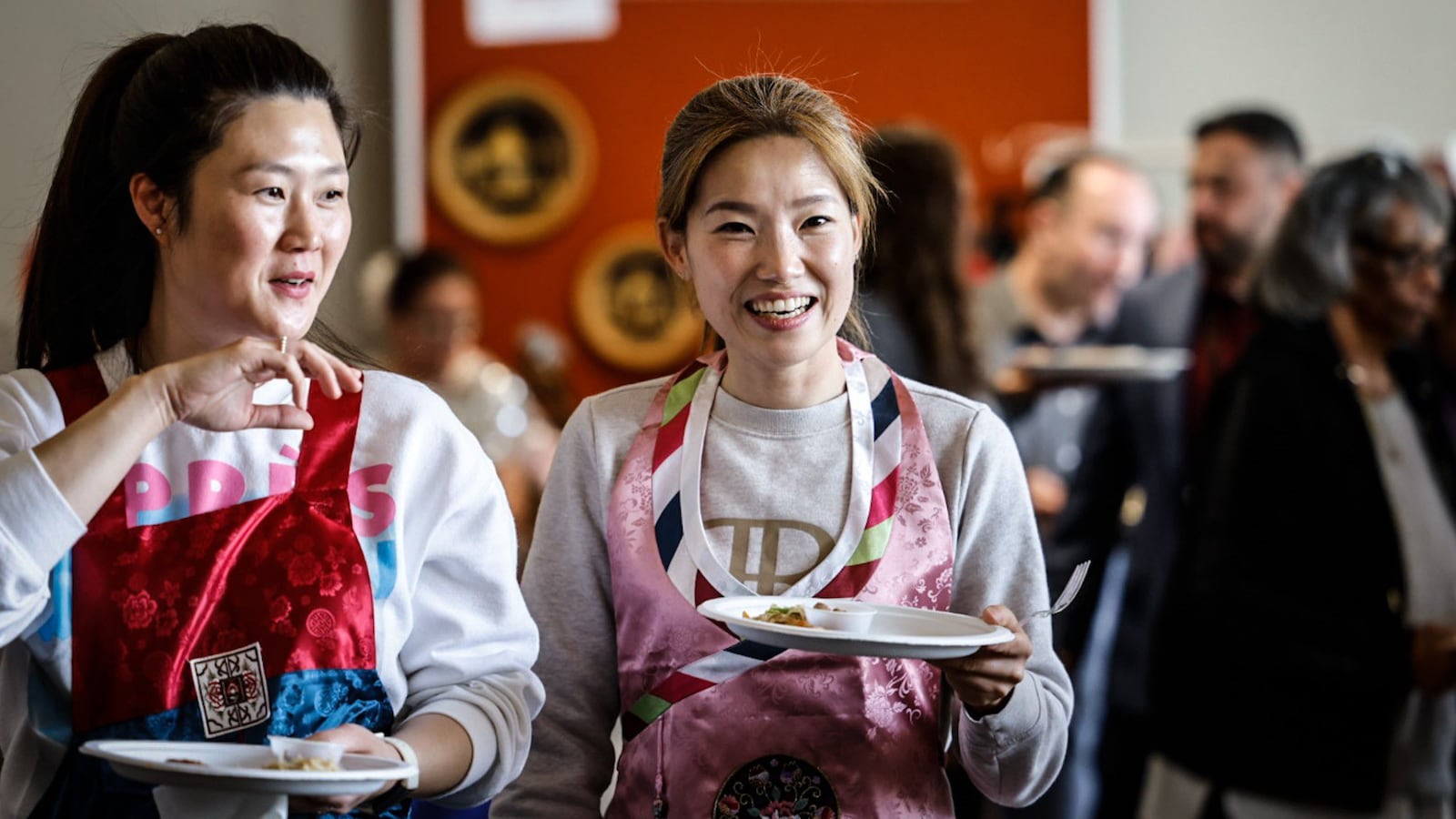 Jiae Kim, left and Kayoung Kim both from South Korea enjoy food at the International Fair held at WPAFB April 26, 2023. The fair is organized by the Wright Patterson International Spouses Group which represents 31 countries from around the globe. JIM NOELKER/STAFF