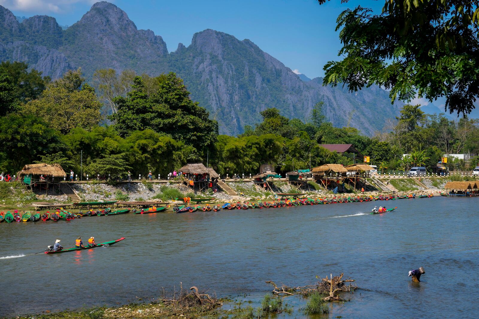 Foreign tourists ride on boat in a river in Vang Vieng, Laos, Friday, Nov. 22, 2024. (AP Photo/Anupam Nath)