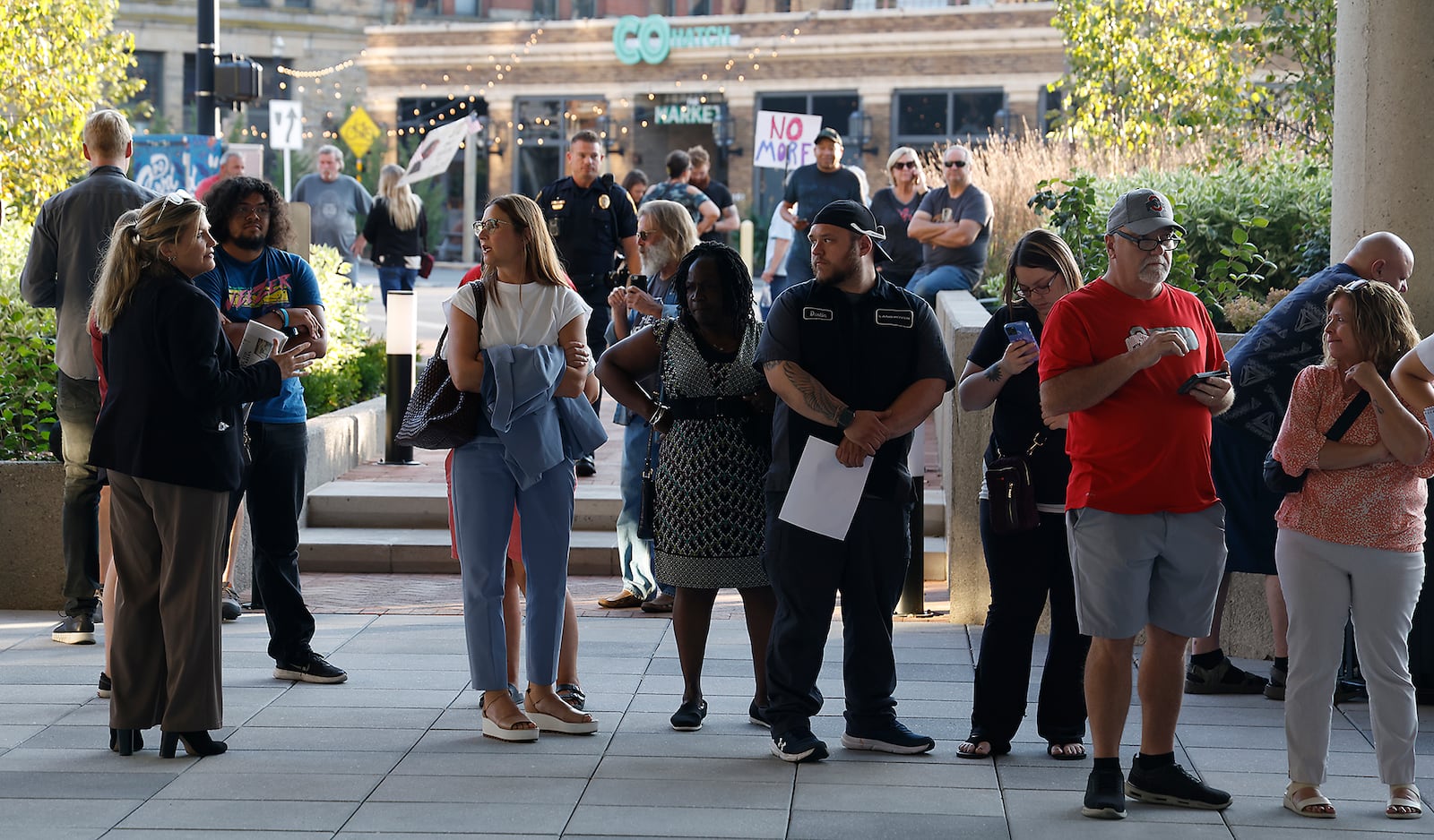 A crowd of people wait outside the Springfield City Commission Meeting, unable to get inside because capacity had been reached in the City Hall Forum Tuesday, Sept. 10, 2024. BILL LACKEY/STAFF