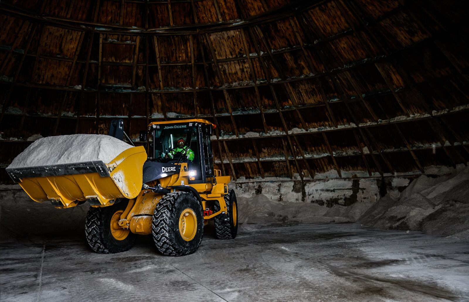 A frontend loader scops-up a load of salt at the Montgomery County Engineer's office on Little Richmond Rd in Trotwood Monday January 23, 2023. Workers were busy cleaning trucks and loading salt in preparation to Tuesday nights expected snowstorm. JIM NOELKER/STAFF