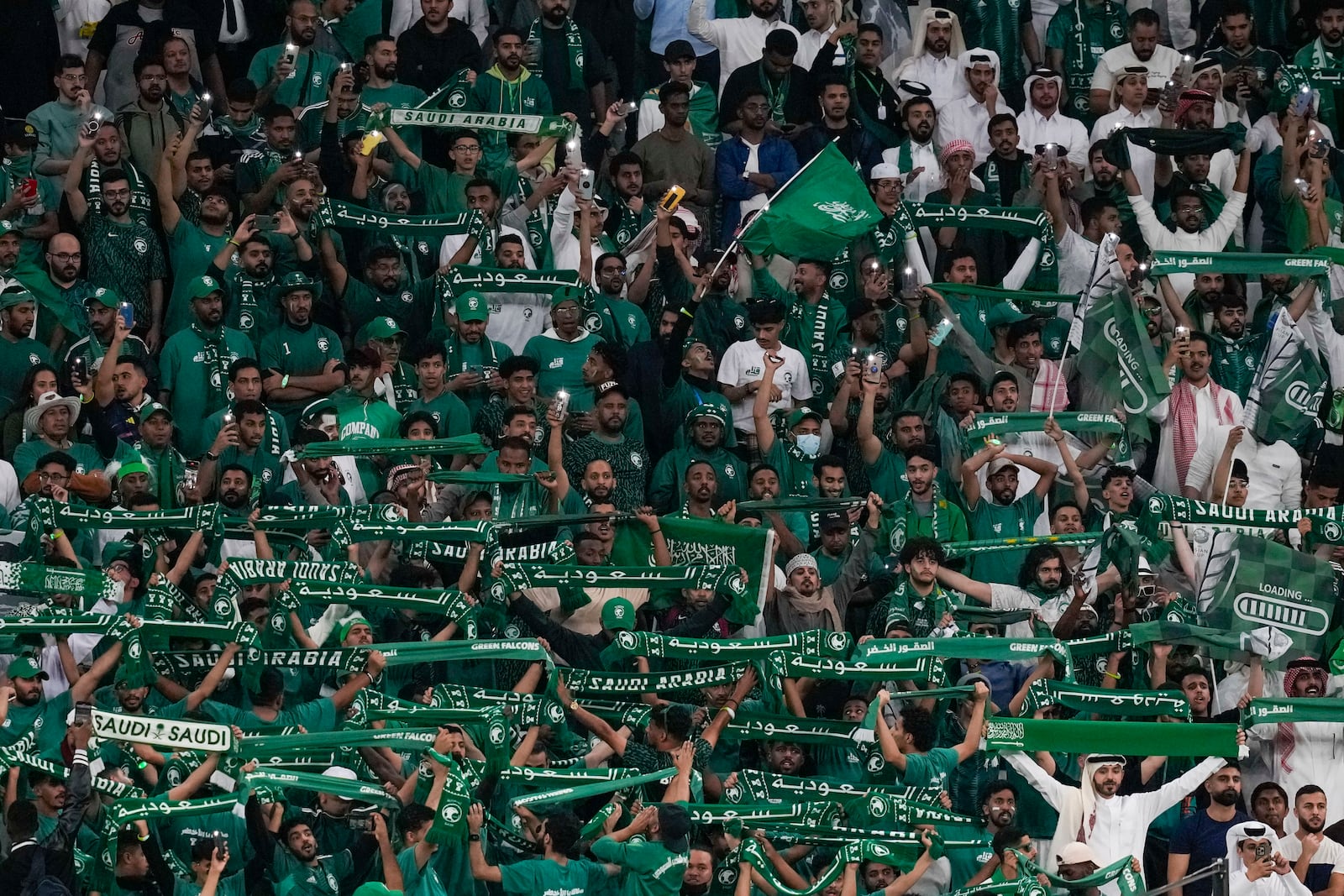 FILE - Saudi Arabia fans support their team during the Asian Cup Round of 16 soccer match between Saudi Arabia and South Korea, at the Education City Stadium in Al Rayyan, Qatar, Tuesday, Jan. 30, 2024. . (AP Photo/Thanassis Stavrakis, File)