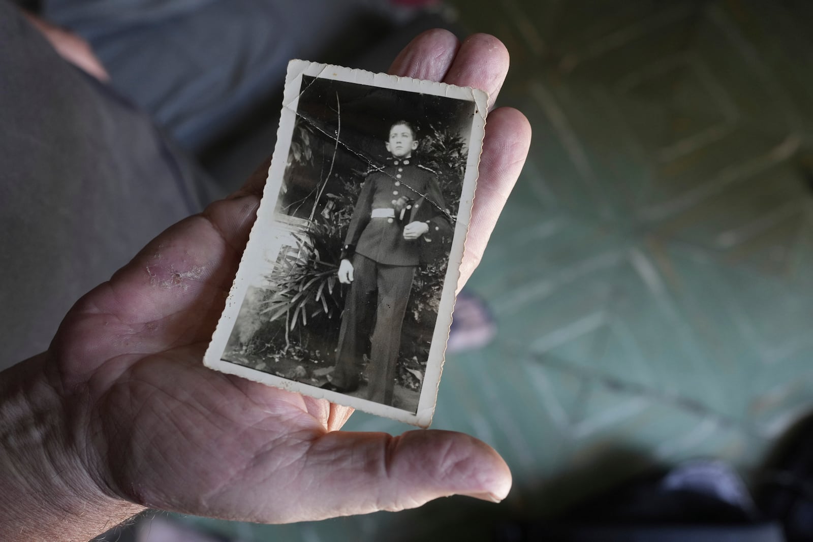 Federico Tatter holds a photo of his father, who was detained and disappeared in Argentina in 1976 during Paraguay's Stroessner dictatorship, during an interview at the Military Academy in Asuncion, Paraguay, Tuesday, Oct. 29, 2024. (AP Photo/Jorge Saenz)