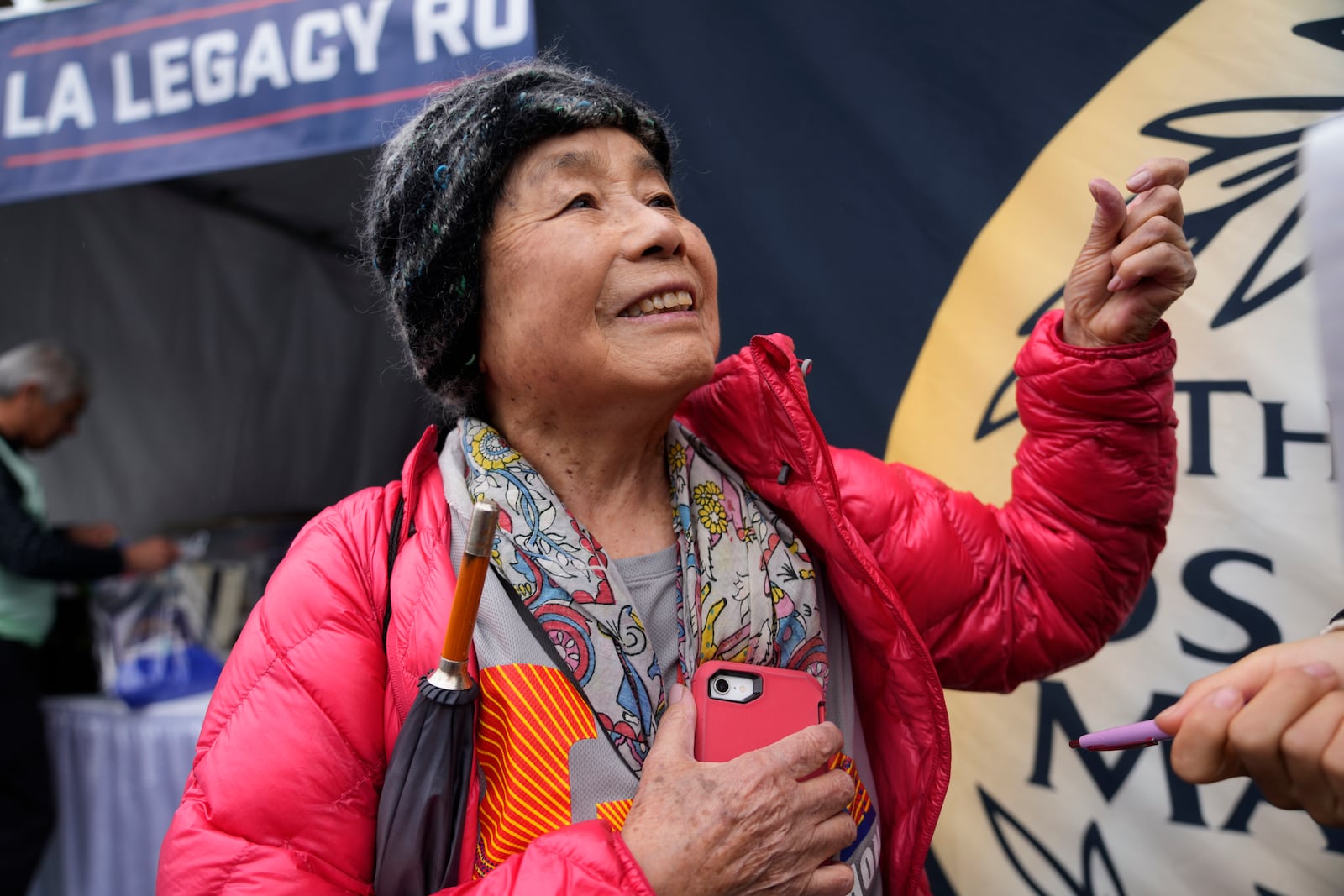 Masako Higuchi, 83, gathers with other runners ahead of the Los Angeles Marathon at the Lifestyle Expo at Dodger Stadium, Friday, March 14, 2025 in Los Angeles. (AP Photo/Damian Dovarganes)