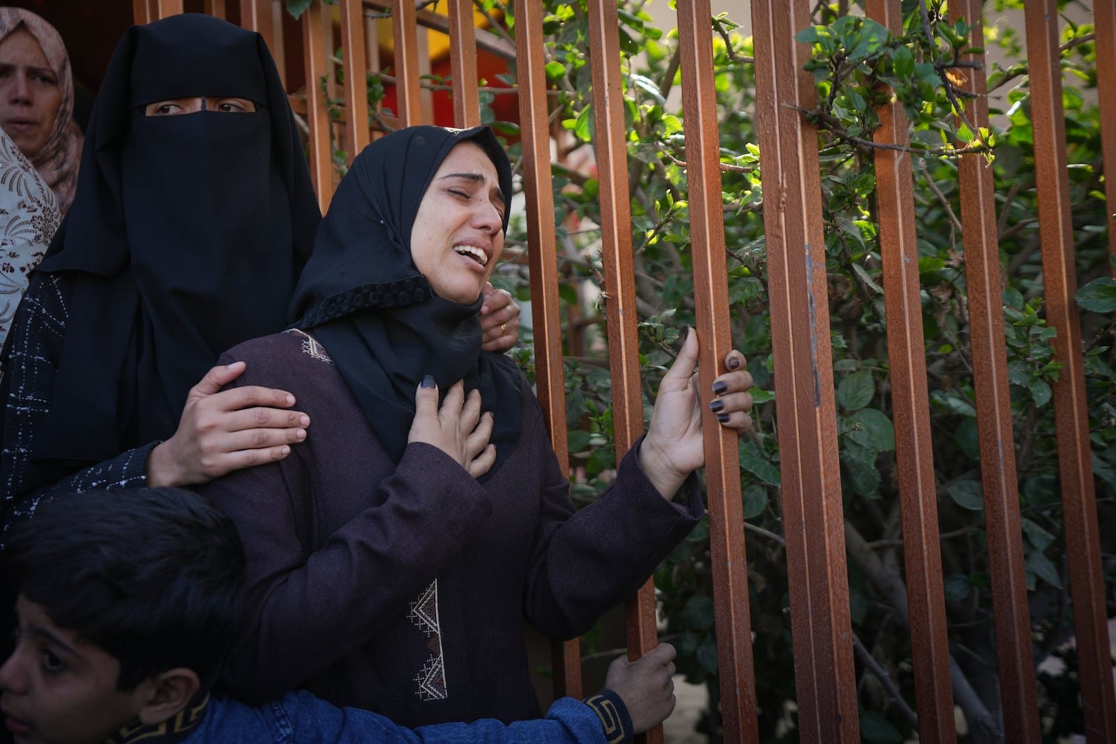 A woman weeps during the funeral of the victims of an Israeli army airstrike in Deir al-Balah, Gaza Strip, Thursday Nov. 21, 2024. Palestinian health officials say the death toll in the Gaza Strip from the 13-month-old war between Israel and Hamas has surpassed 44,000. (AP Photo/Abdel Kareem Hana)