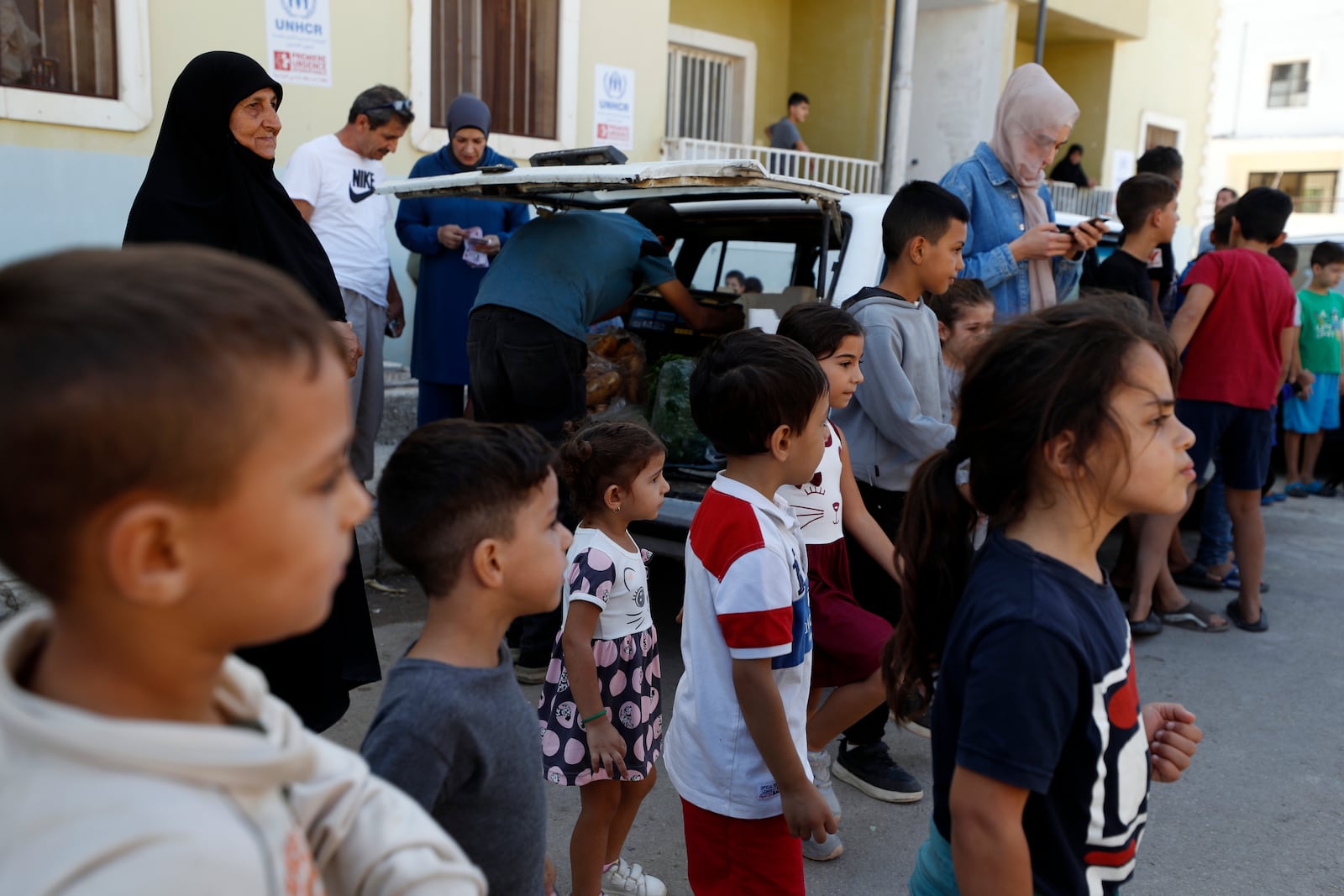 Displaced families fleeing the war in Lebanon, gather at the Herjalleh shelter center in Damascus countryside, Syria, Tuesday, Oct. 15, 2024. (AP Photo/Omar Sanadiki)