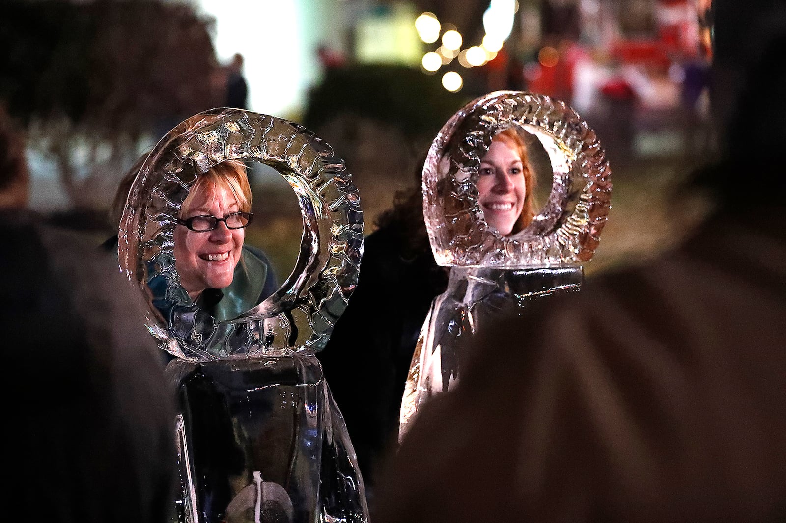 Juliann Ianni and her daughter Allison pose for picture with the ice sculptures at Holiday in the City. Bill Lackey/Staff