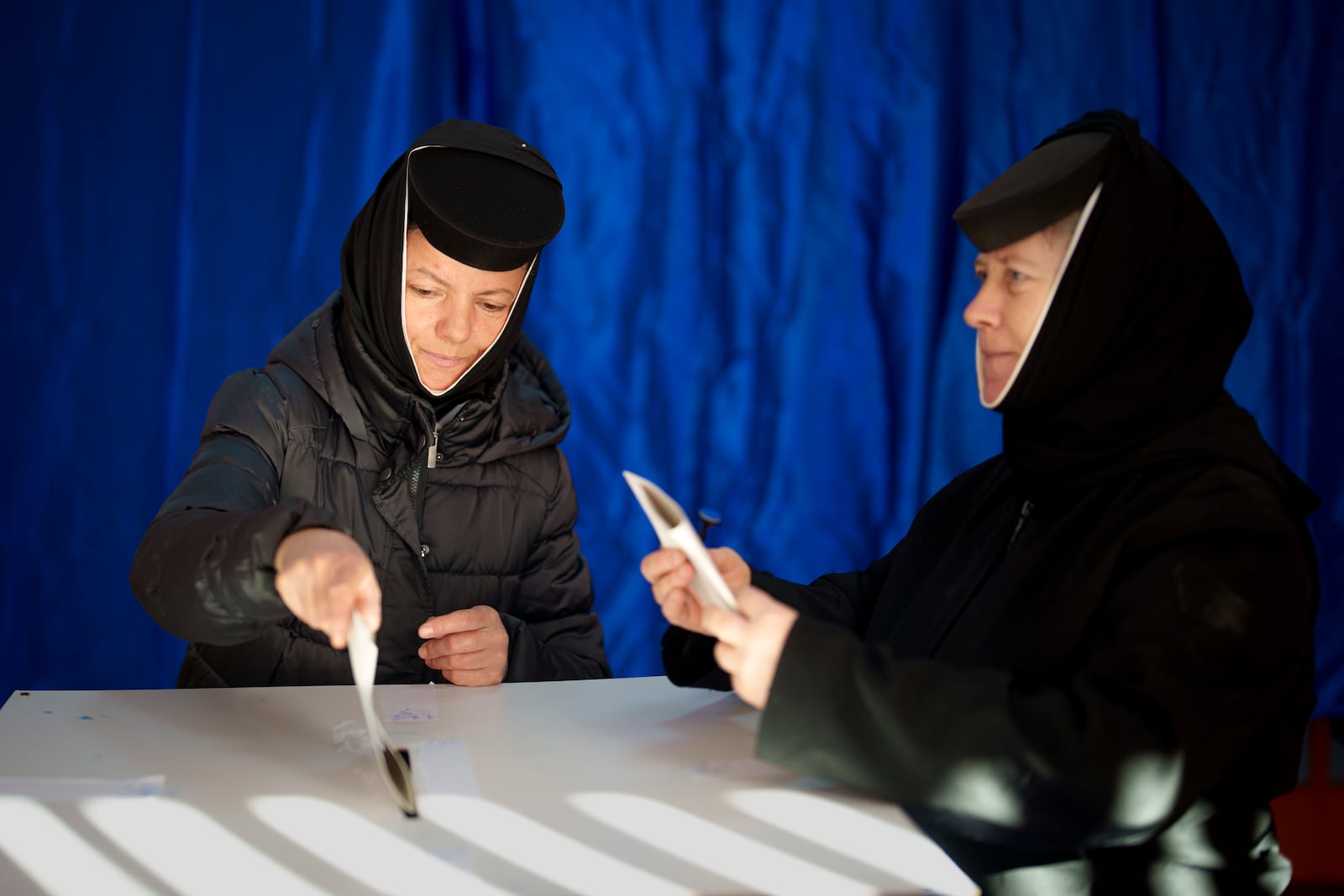 Orthodox nuns cast their vote in the country's presidential elections, in Pasarea, Romania, Sunday, Nov. 24, 2024. (AP Photo/Vadim Ghirda)