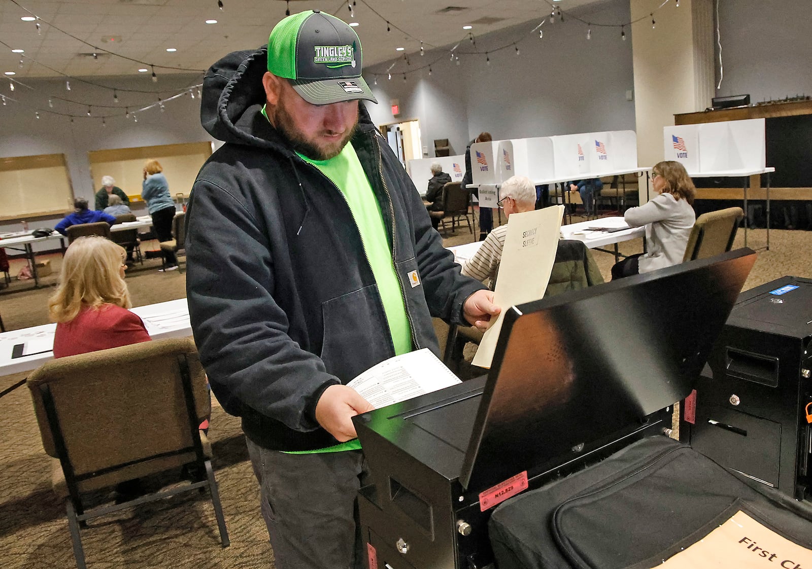 Casey Tingley puts his ballot in the voting machine Tuesday, March 19, 2024 at the First Christian Church on Middle Urbana Road. BILL LACKEY/STAFF