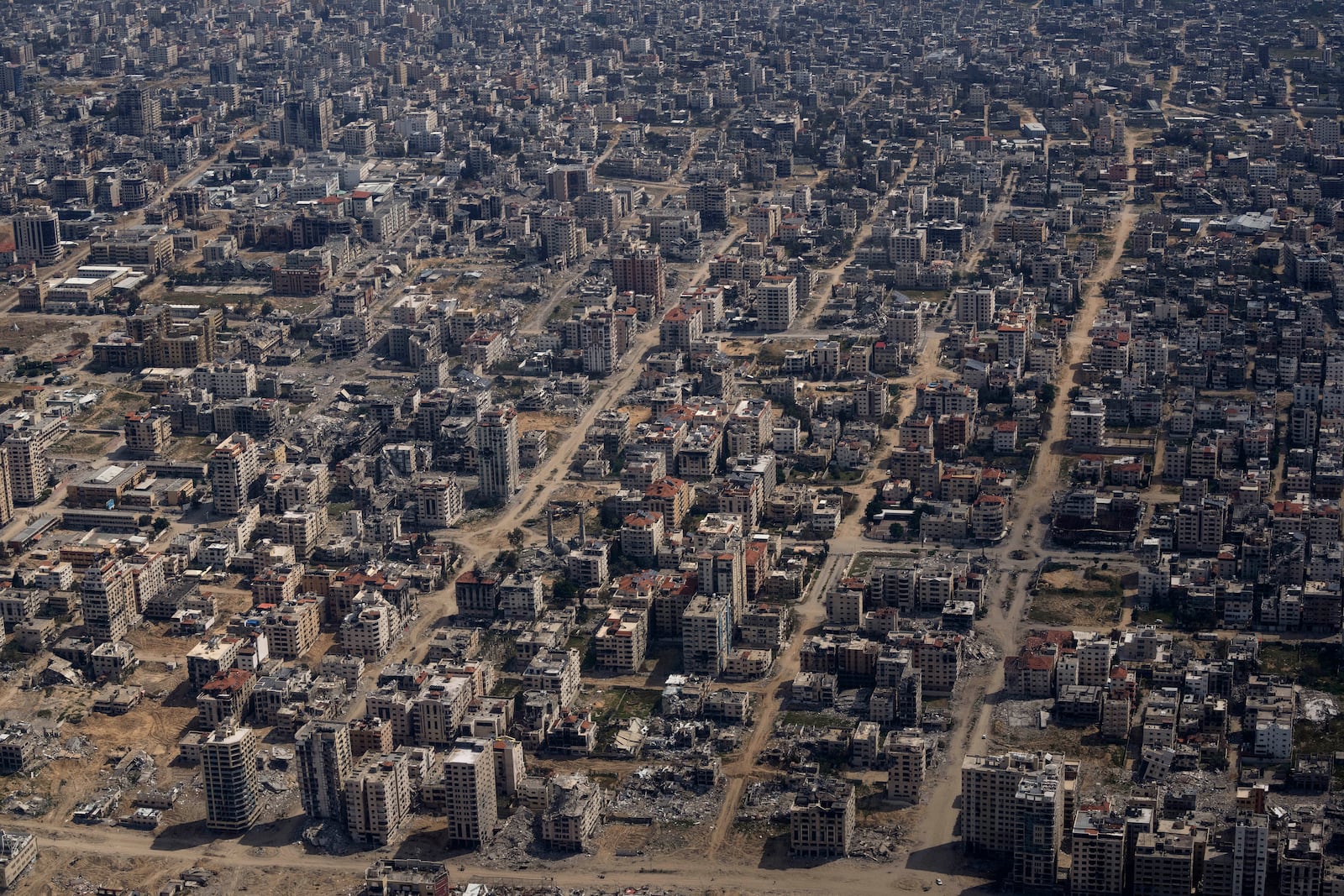 FILE - Destroyed buildings are seen from an U.S. Air Force plane flying over the Gaza Strip, on March 14, 2024. (AP Photo/Leo Correa, File)