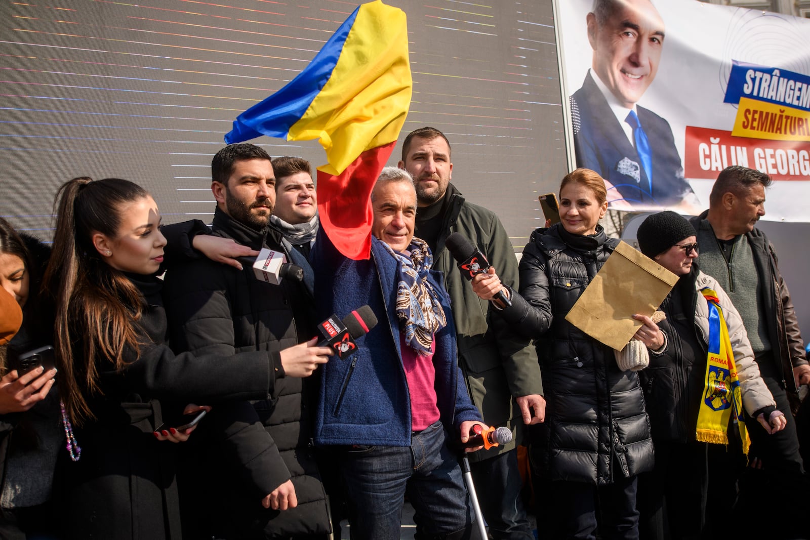 Calin Georgescu, the winner of Romania's first round of presidential election, annulled by the Constitutional Court, waves to supporters gathered for a protest outside the Romanian parliament in Bucharest, Romania, Saturday, Feb. 22, 2025. (AP Photo/Alexandru Dobre)