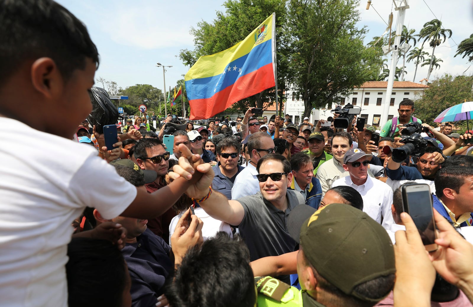 FILE - U.S. Senator Marco Rubio, R-Fla., greets Venezuelan migrants near the Simon Bolivar International Bridge, in La Parada, near Cucuta, Colombia, Feb. 17, 2019. (AP Photo/Fernando Vergara, File)