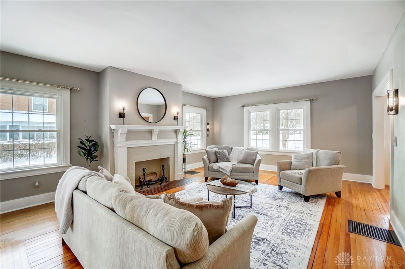 The living room has original hardwood flooring, a gas fireplace and built in bookcases. A sitting room is connected to this room.