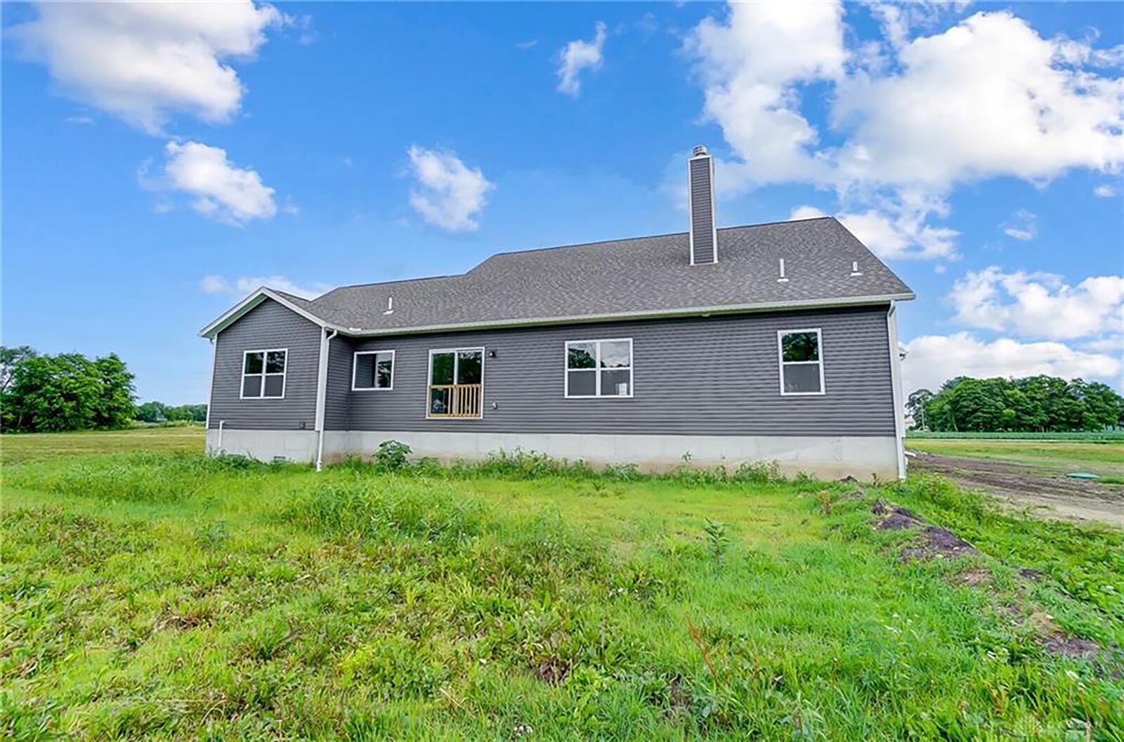 The rear of the home has a sliding glass door off the breakfast area and is ready to finish with a deck or patio. It sits on a crawl space and the lot is 18 acres.