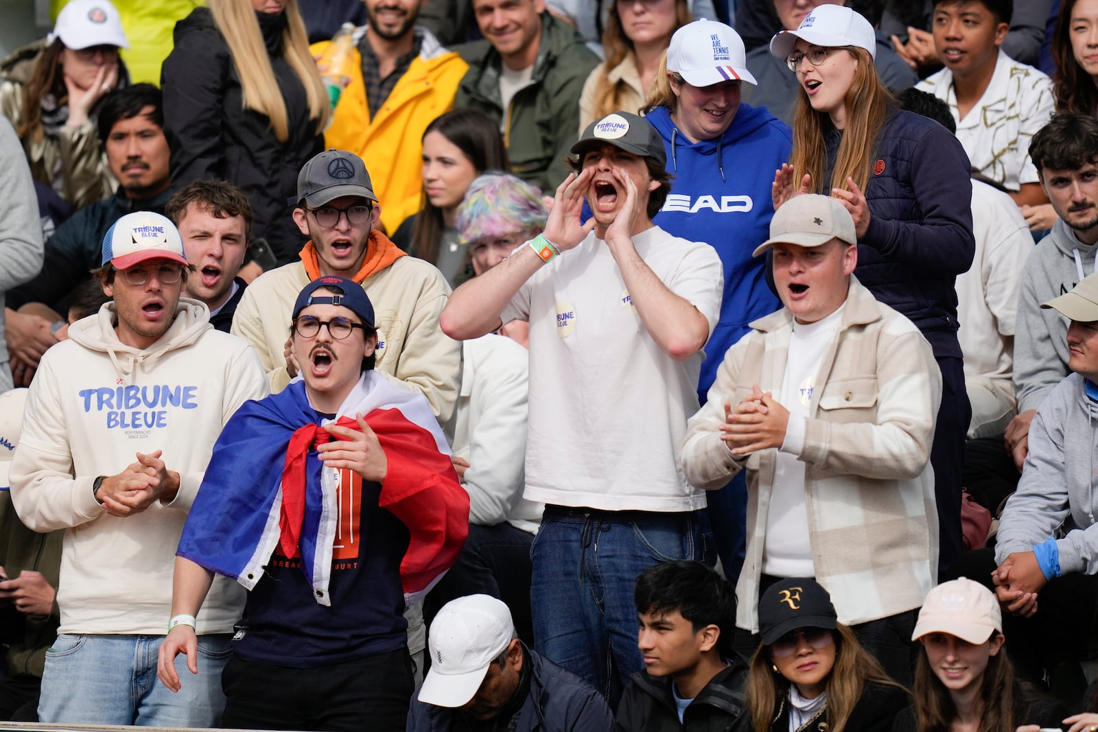 FILE - Tennis fans scream during second round matches of the French Open tennis tournament at the Roland Garros stadium in Paris, Thursday, May 30, 2024. (AP Photo/Thibault Camus, File)