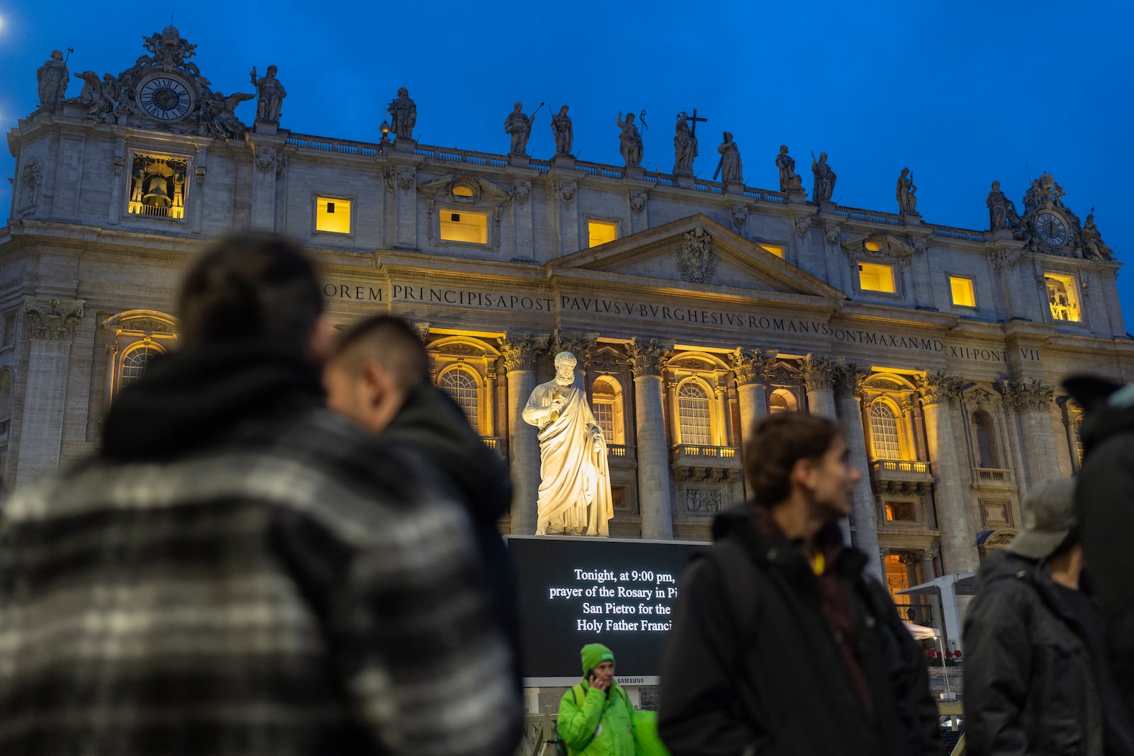 People wait in St. Peter's Square at The Vatican for the start of a rosary vigil prayer for Pope Francis' recovery, Monday, Feb. 24, 2025. (AP Photo/Mosa'ab Elshamy)