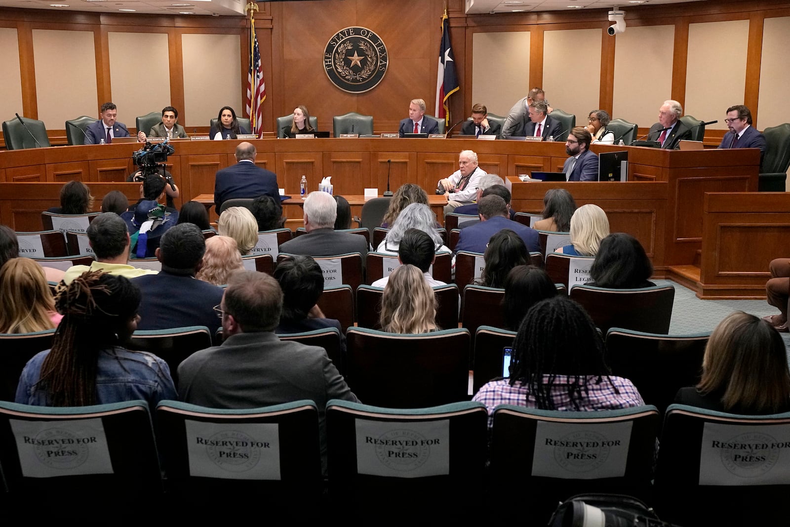 Dr. Phil McGraw, in blue suit sitting at table, gives testimony to the state House Committee on Criminal Jurisprudence during a committee hearing in the case of death row inmate Robert Roberson, Monday, Oct. 21, 2024, in Austin, Texas. (AP Photo/Tony Gutierrez)