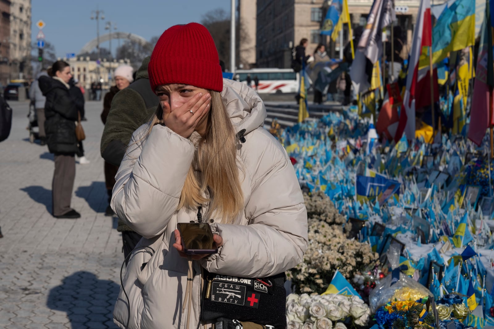 A woman cries at the memorial to the fallen Ukrainian soldiers on Independence Square in Kyiv, Ukraine, Monday, Feb. 24, 2025. (AP Photo/Efrem Lukatsky)