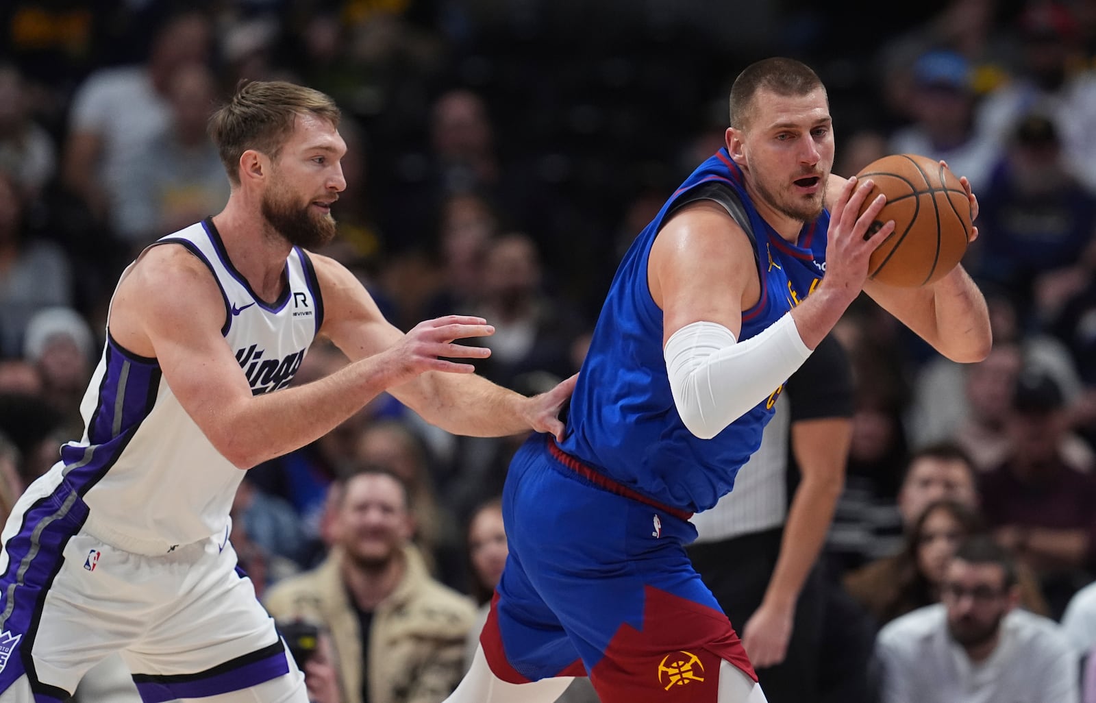 Denver Nuggets center Nikola Jokic, right, collects the ball as Sacramento Kings forward Domantas Sabonis defends in the first half of an NBA basketball game Thursday, Jan. 23, 2025, in Denver. (AP Photo/David Zalubowski)