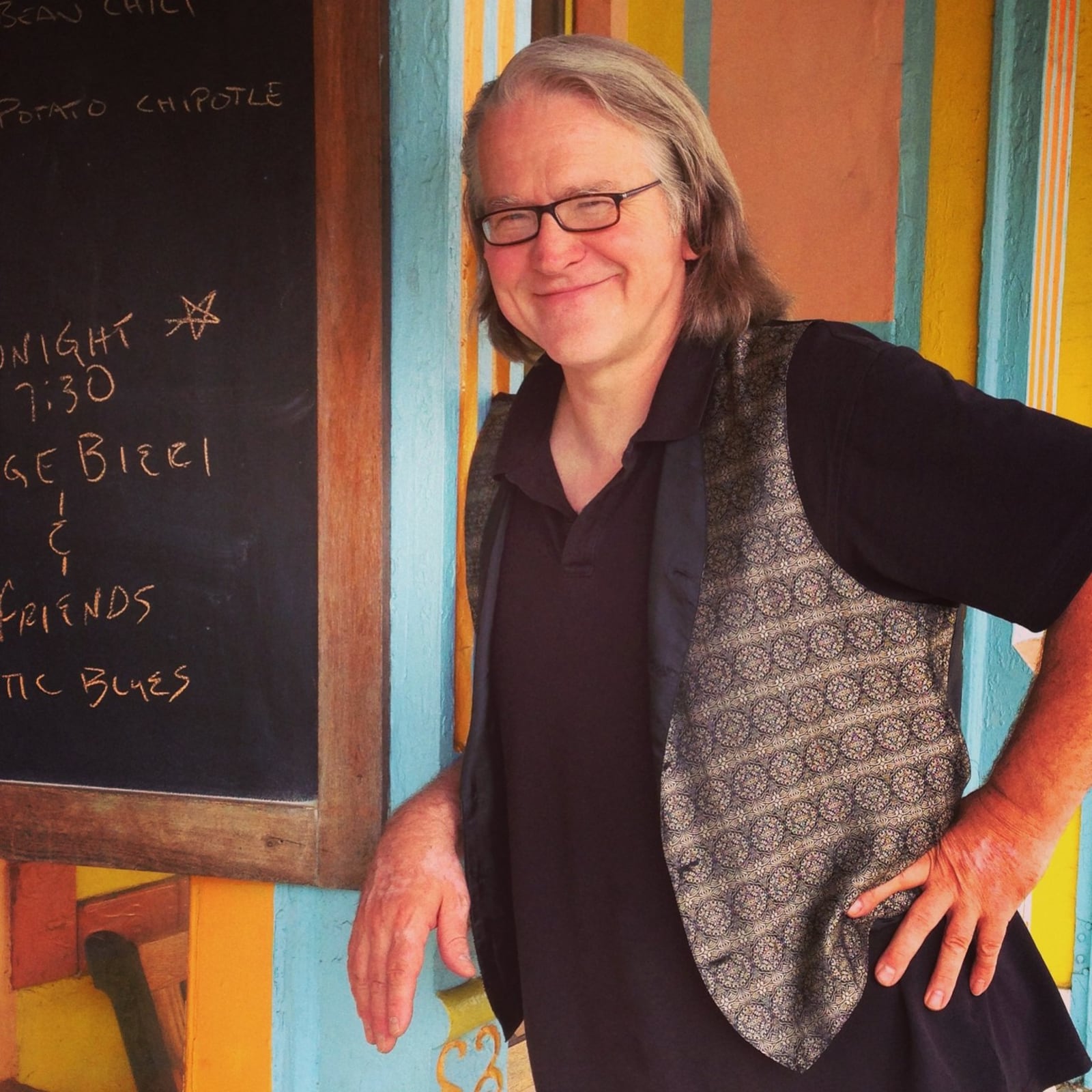 Dayton Daily News Book Nook columnist Vick Mickunas outside Yellow Springs’ Sunrise Cafe, where there is a burger named after him. (Staff photo by Connie Post)