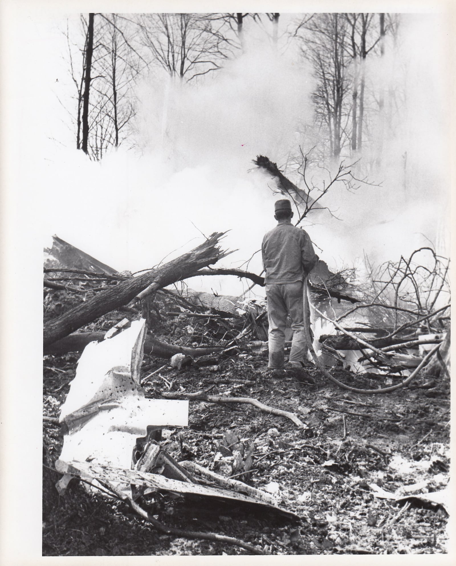 Investigators look over the plane crash debris in rural Champaign County on March 9, 1967. Archive photos