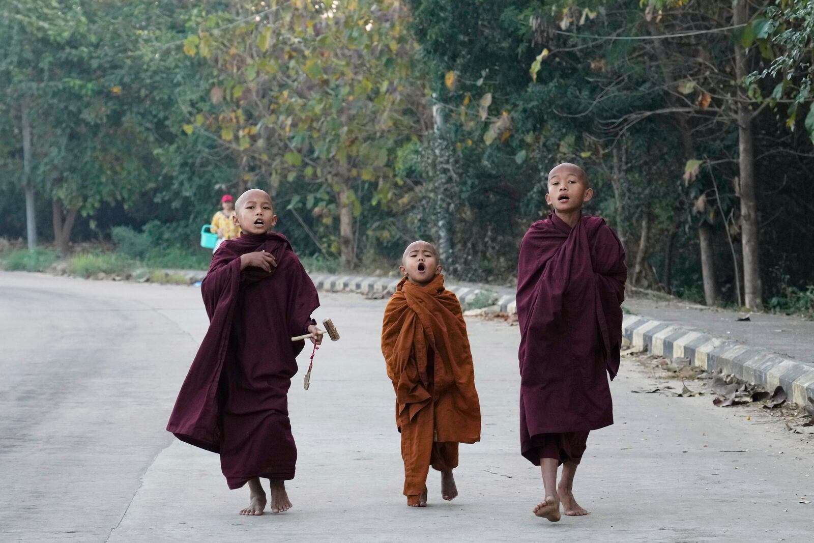 Buddhist novice monks shout to collect their morning alms Saturday, Feb. 1, 2025, in Naypyitaw, Myanmar. (AP Photo/Aung Shine Oo)