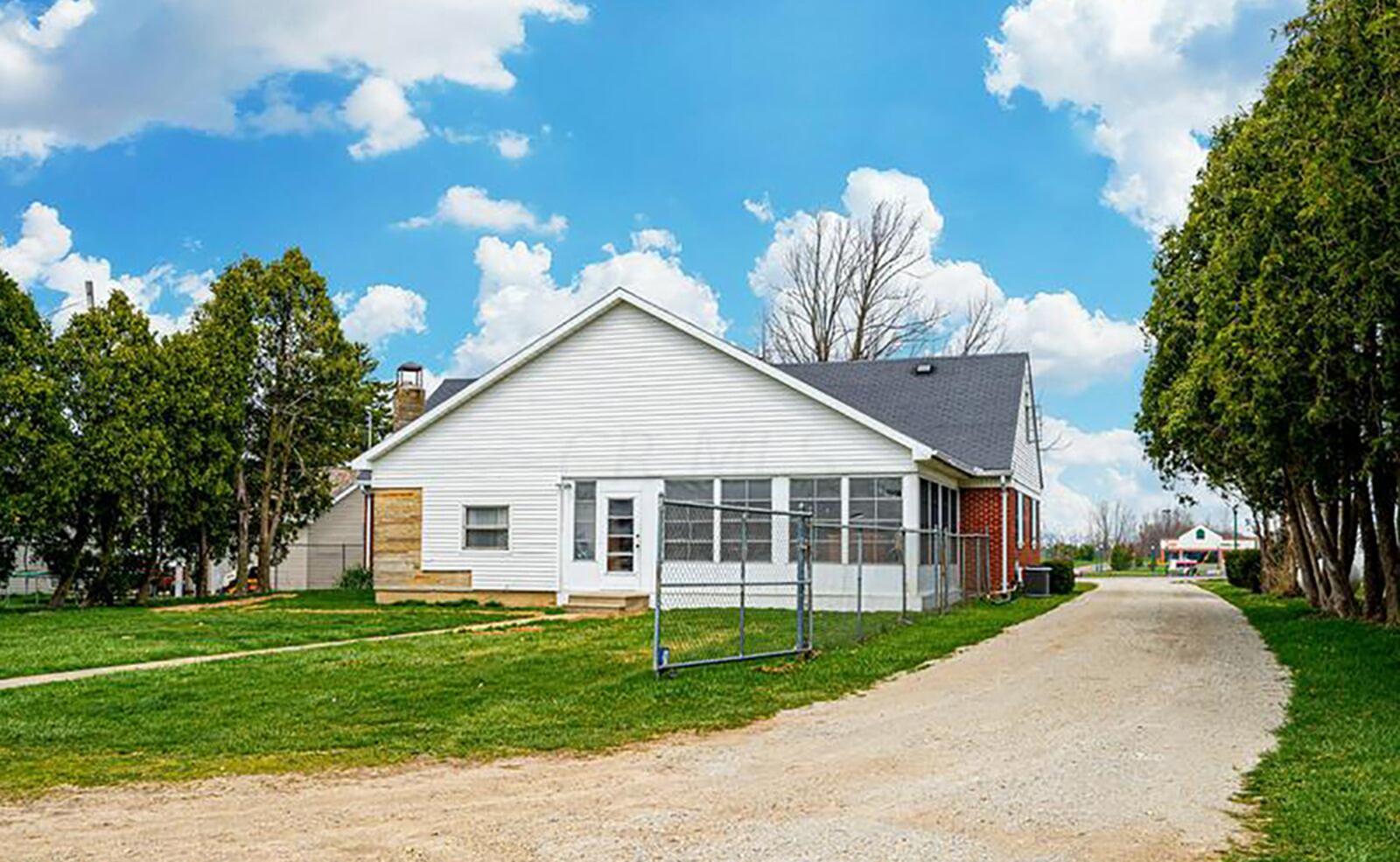 The rear of the home features a 3-season room that overlooks a .69-acre lot with woods to the rear. A detached garage can hold 6 cars. CONTRIBUTED PHOTO