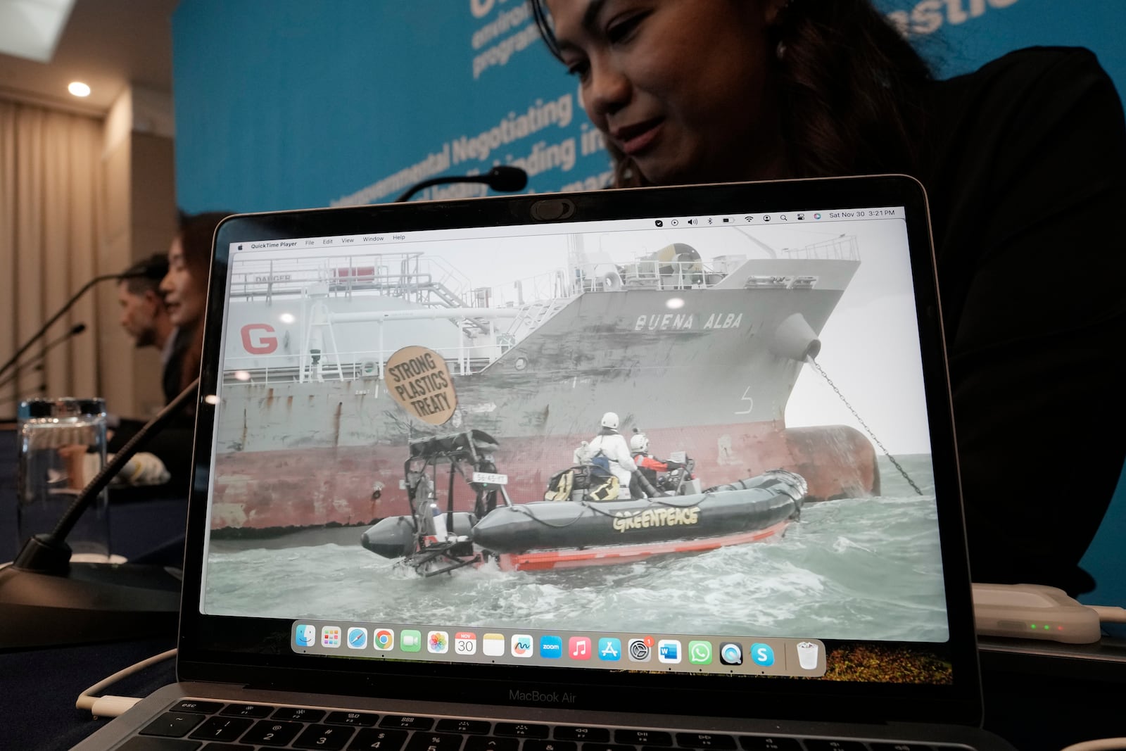 A screen shows Greenpeace activists boarding a tanker on Saturday, to demand that nations agree to reduce plastic production, during a press conference of Greenpeace at the fifth session of the Intergovernmental Negotiating Committee on Plastic Pollution in Busan, South Korea, Saturday, Nov. 30, 2024. (AP Photo/Ahn Young-joon)