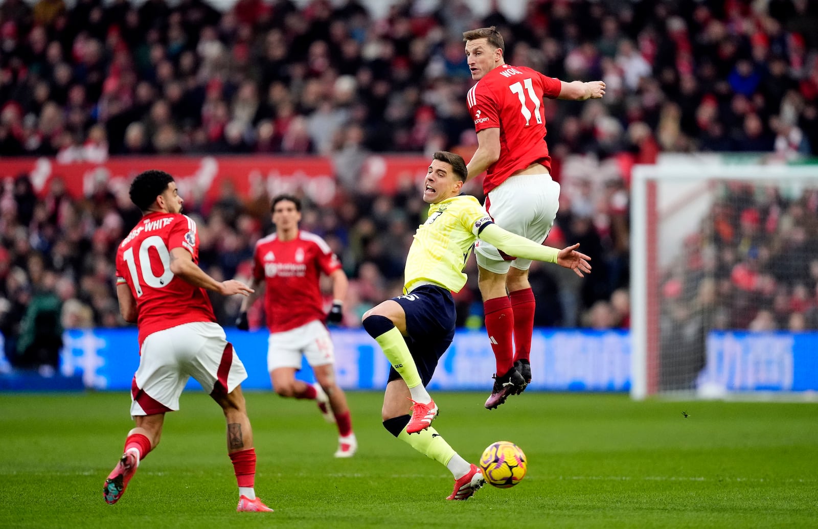 Nottingham Forest's Chris Wood jumps above Southampton's Jan Bednarek during the English Premier League soccer match between Nottingham Forest and Southampton at the City Ground, Nottingham, England, Sunday, Jan. 19, 2025. (Nick Potts/PA via AP)