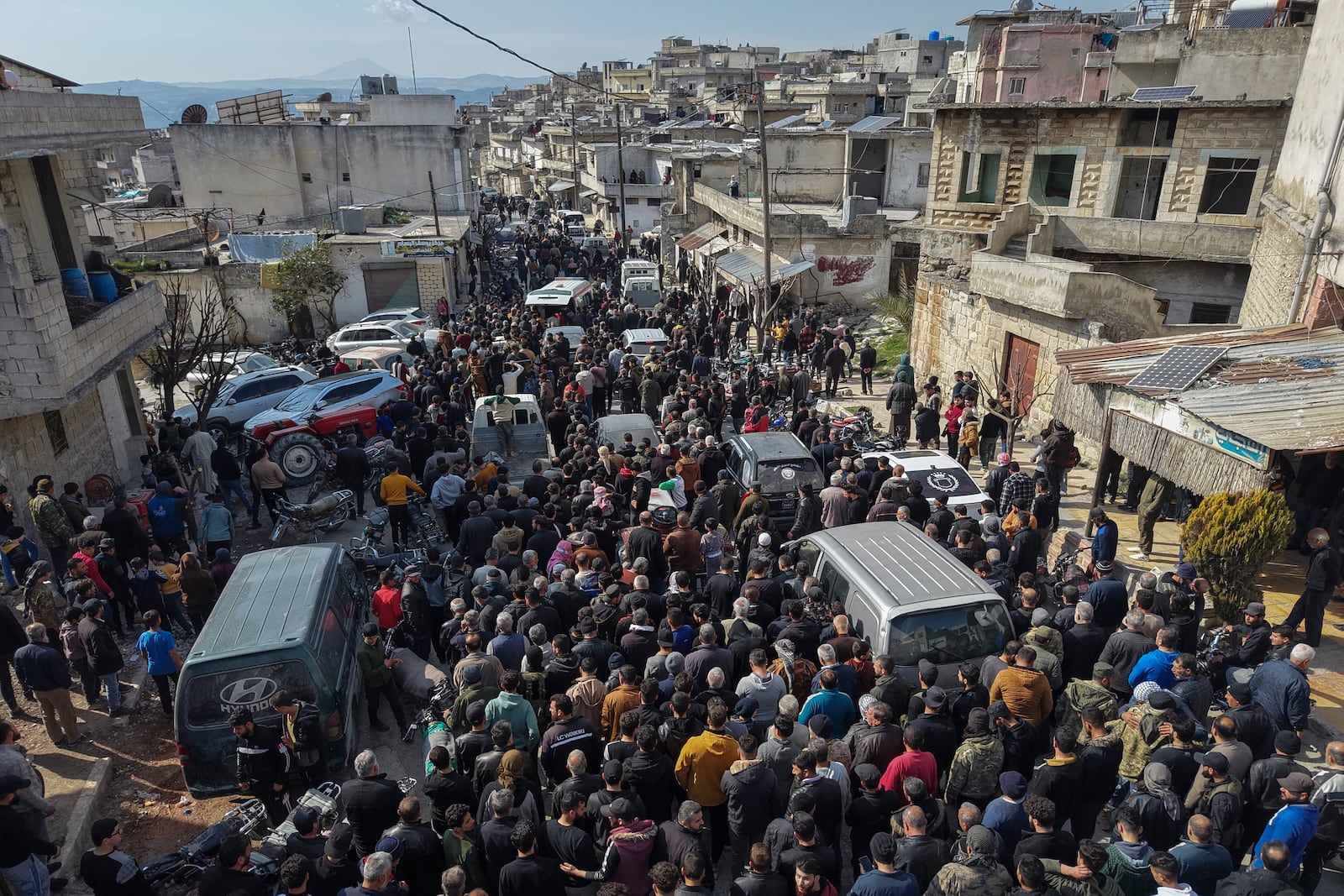 Relatives and neighbours attend the funeral procession for four Syrian security force members killed in clashes with loyalists of ousted President Bashar Assad in coastal Syria, in the village of Al-Janoudiya, west of Idlib, Saturday, March 8, 2025. (AP Photo/Omar Albam)