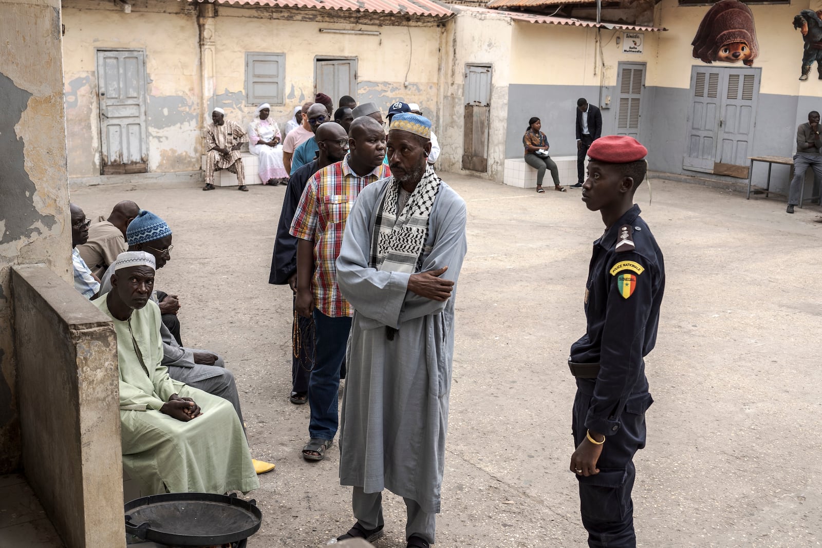 People wait to cast their ballot for legislative elections in Dakar, Senegal Sunday, Nov. 17, 2024. (AP Photo/Annika Hammerschlag)