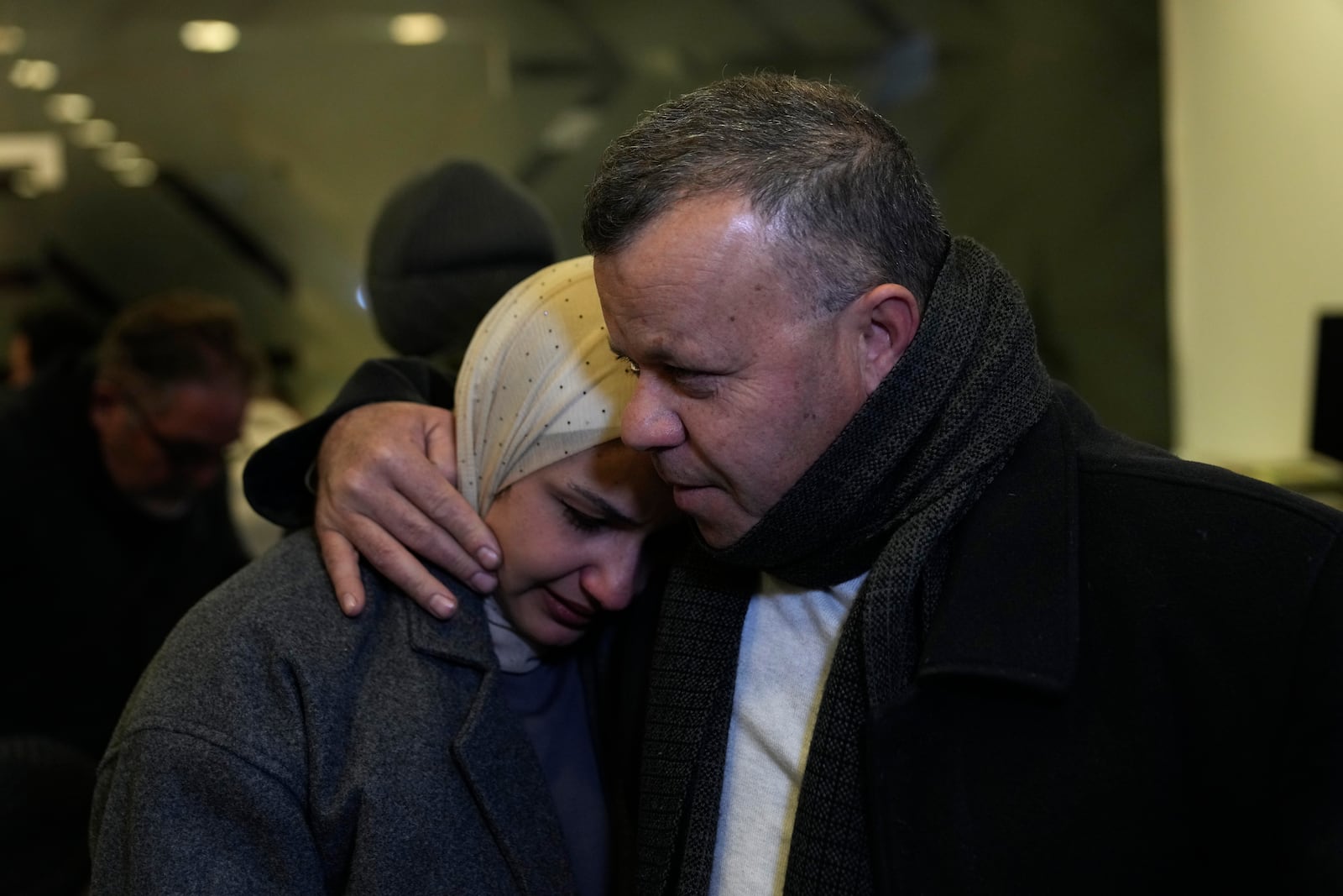 Nadeen, 36, who was waiting for the release of her brother, Ahamd al-Seifi, 35, after he serving 15 years in Israeli jails, is comforted by a relative while crying Sunday, Feb. 23, 2025, after receiving news that Israel has delayed the release of hundreds of Palestinian prisoners scheduled for Saturday, in the West Bank city of Ramallah. (AP Photo/Nasser Nasser)