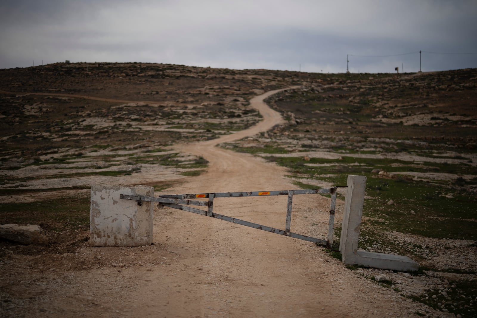 A gate blocks the access for Palestinians, according to local residents, on an area of an Israeli settlers’ outpost near the West Bank village of Tuwani, Monday, March 3, 2025. (AP Photo/Leo Correa)