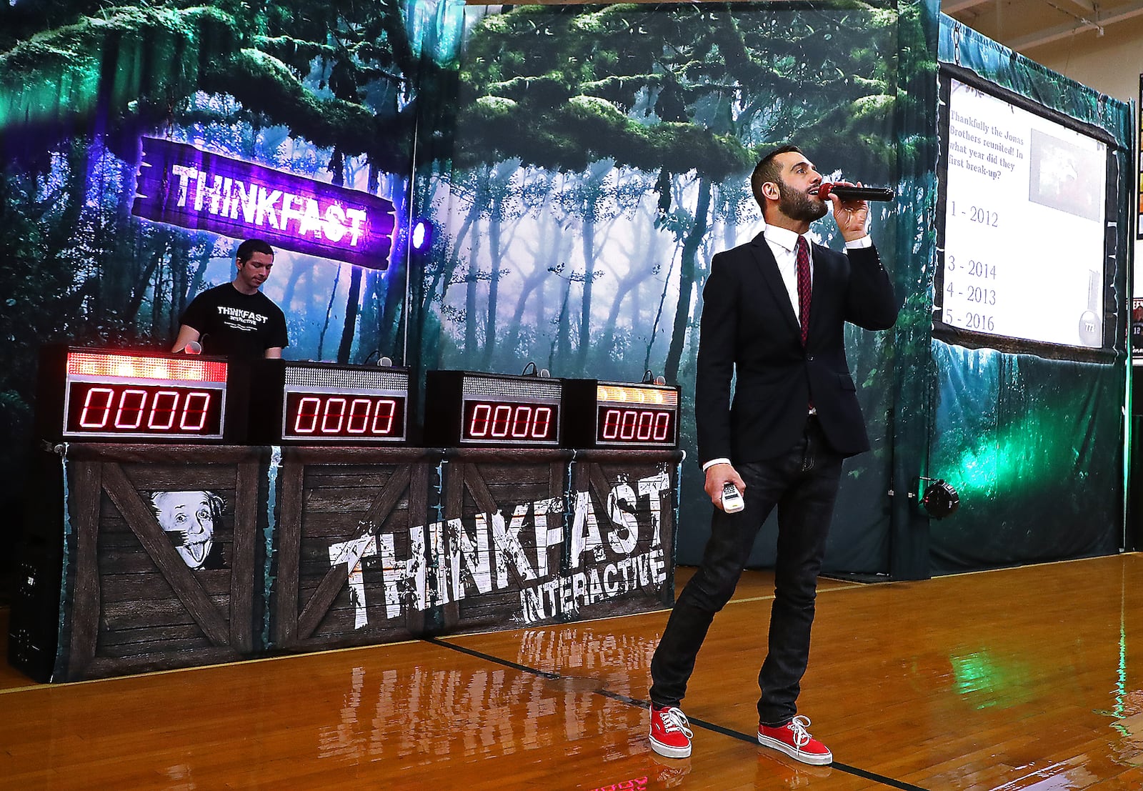 Mattew Karstem, the host of Thinkfast Interactive, asks the Greenon High School student questions about distracted driving during the gameshow style educational program Tuesday in the Greenon gym. BILL LACKEY/STAFF