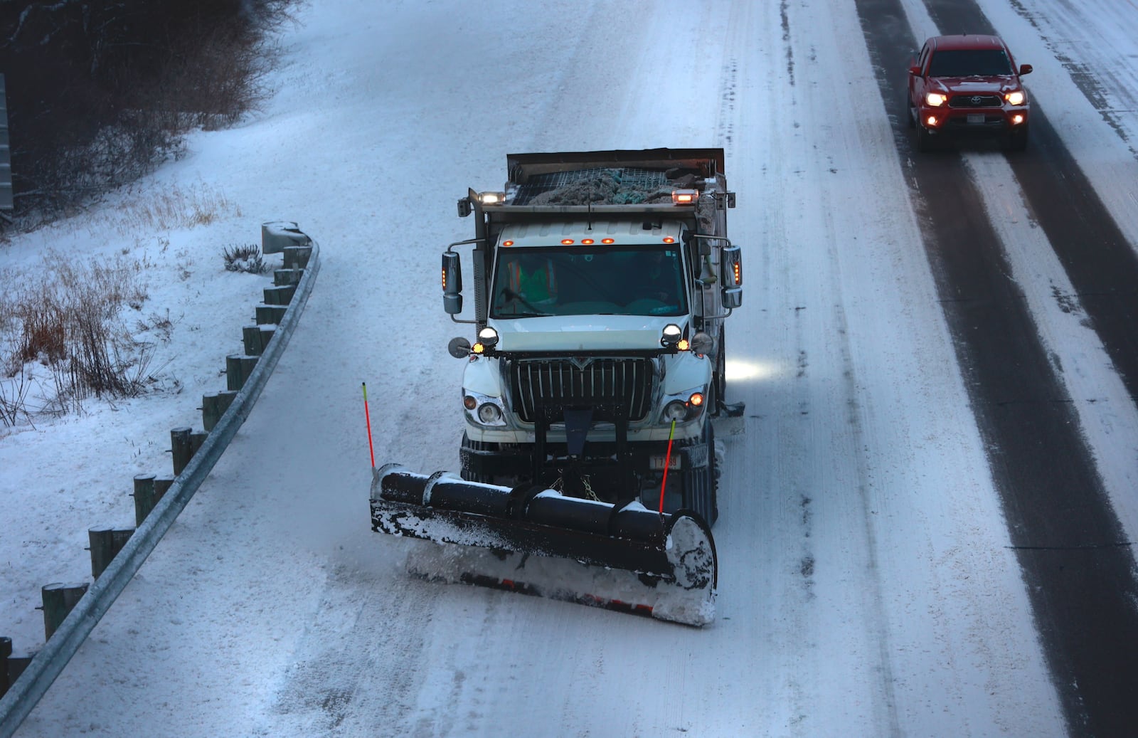 An ODOT plow truck cleans off Interstate 70 in Clark County Friday morning.