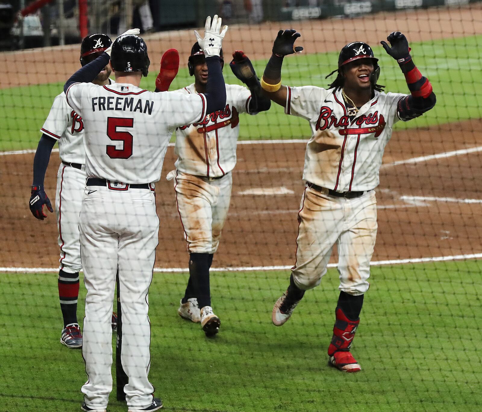 Atlanta Braves Ronald Acuna, right, is greeted at home by Freddie Freeman (5) after he hits a three-run homer for during the fifth inning in a baseball game against the Miami Marlins, Wednesday, Sept. 9, 2020 in Atlanta. (Curtis Compton/Atlanta Journal-Constitution via AP)