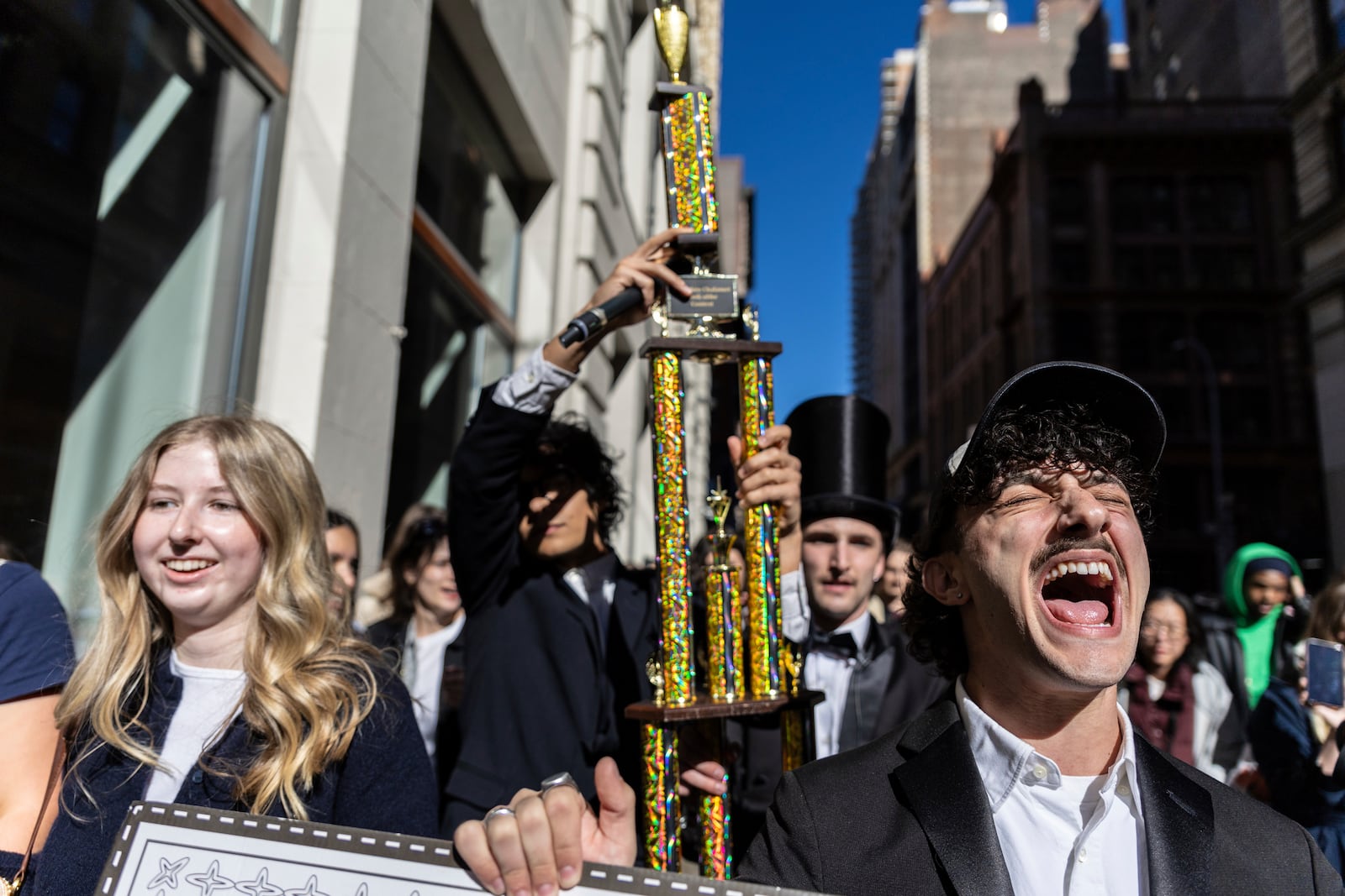 The trophy for the Timothee Chalamet lookalike contest is paraded through the street as the contest organizers move the event to a new location near Washington Square Park, Sunday, Oct. 27, 2024, in New York. (AP Photo/Stefan Jeremiah)