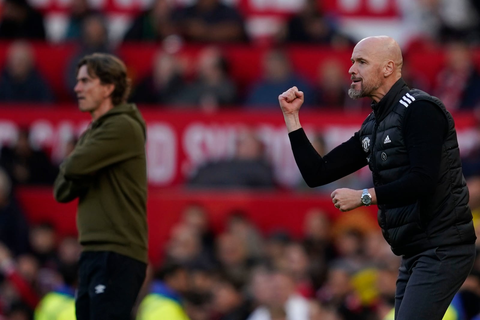 Manchester United's head coach Erik ten Hag, right, and Brentford's head coach Thomas Frank react during the English Premier League soccer match between Manchester United and Brentford at Old Trafford stadium in Manchester, England, Saturday, Oct. 19, 2024. (AP Photo/Dave Thompson)