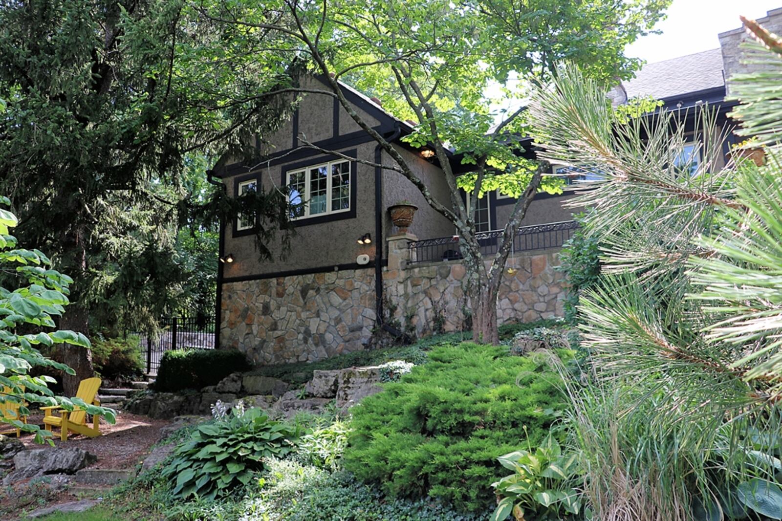 Steps lead down to a graveled sitting area surrounded by terraced gardens.