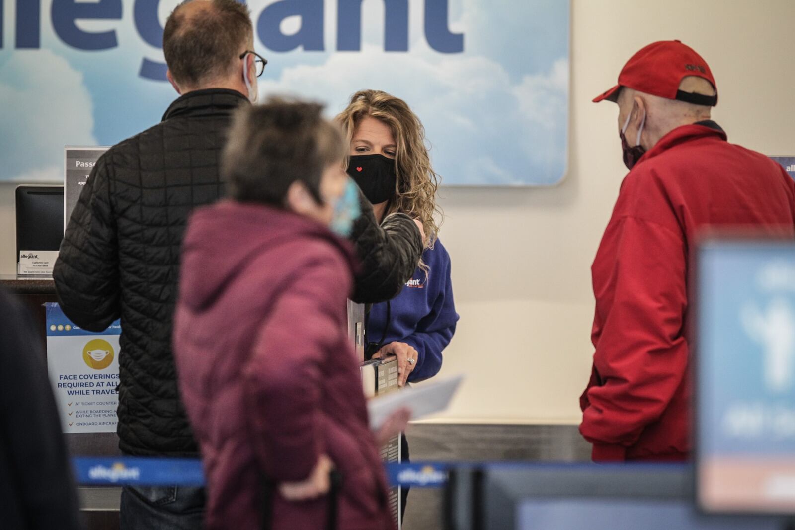 People wait in line at the Allegiant gate at the Dayton airport Monday Dec. 7, 2020. 