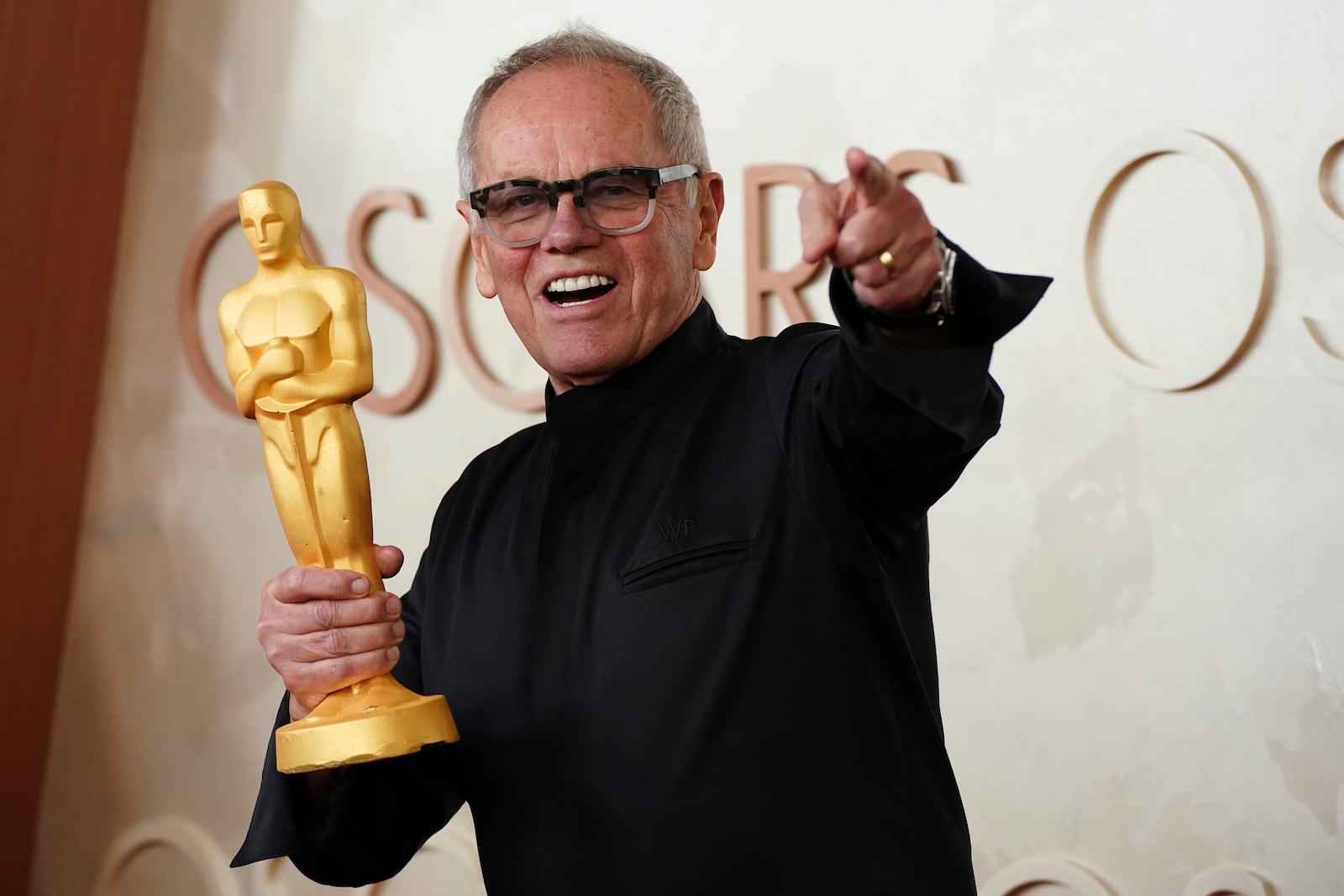 Wolfgang Puck holding a statuette arrives at the Oscars on Sunday, March 2, 2025, at the Dolby Theatre in Los Angeles. (Photo by Jordan Strauss/Invision/AP)