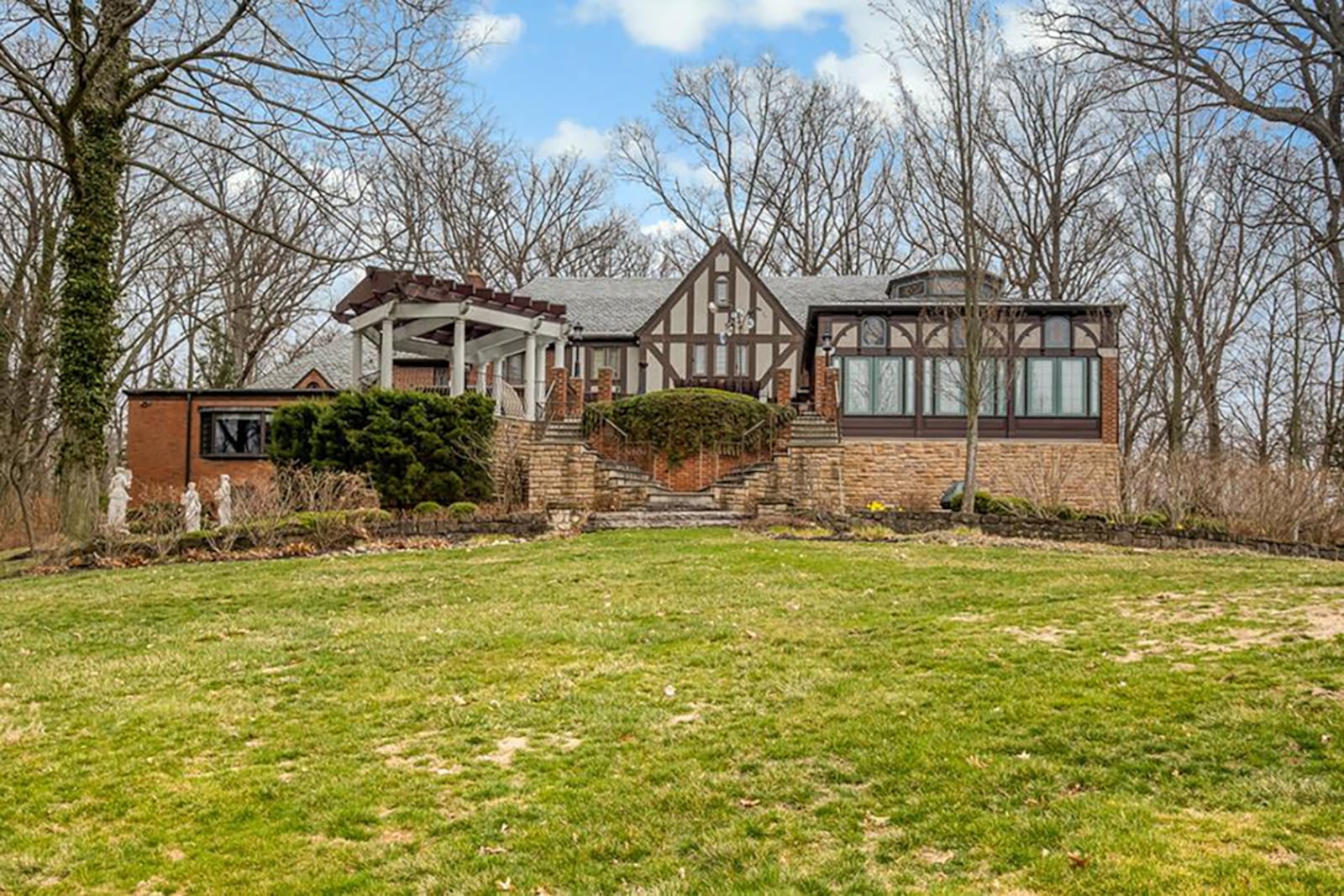 The rear of the home features a sunroom/solarium with doors leading out to the brick-paver patio, a covered gazebo and several pergolas. There is a walk-out lower level, and the lot is wooded. CONTRIBUTED PHOTO