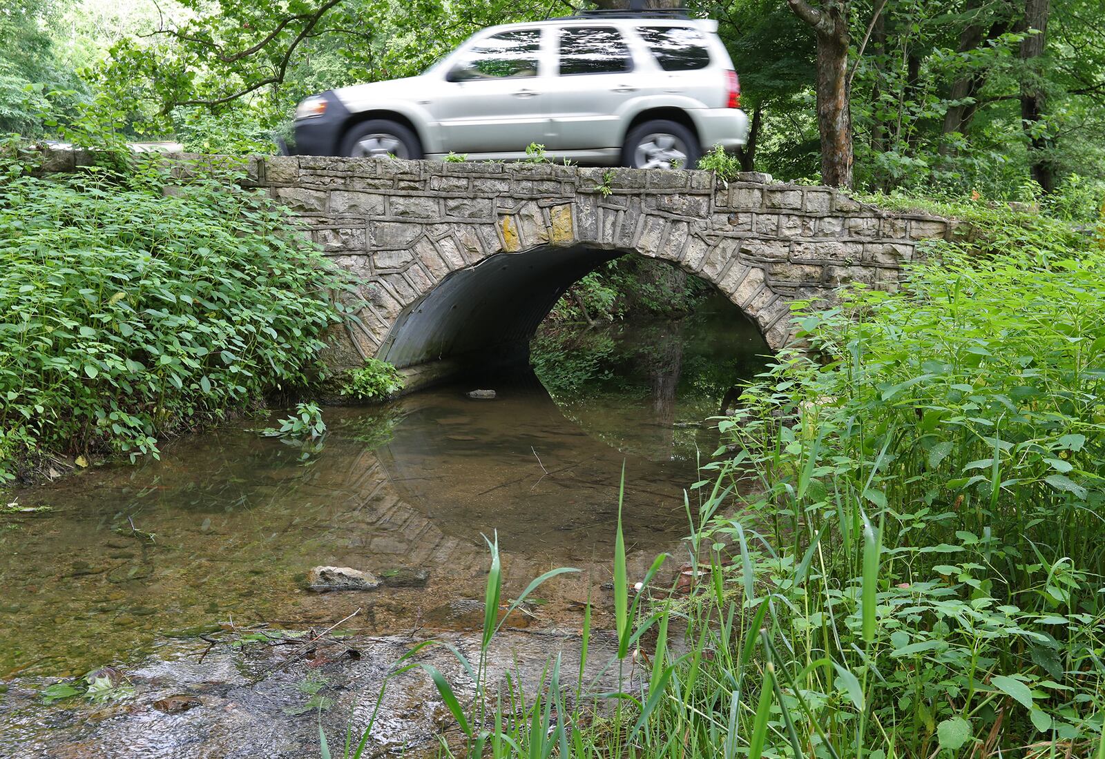 A car drives across the old lower bridge at George Rogers Clark Park on Monday. The bridge is in bad shape and ODOT will replace it next summer. BILL LACKEY / STAFF